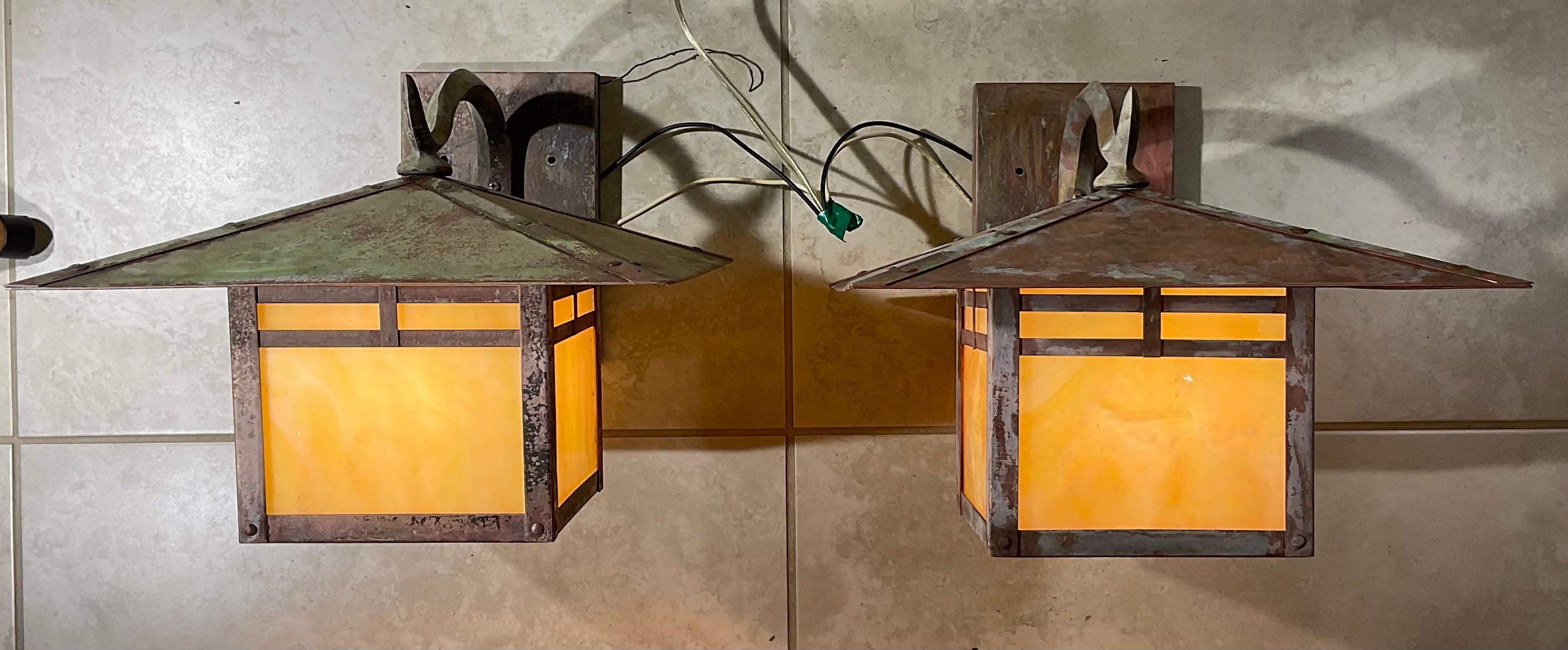 This  pair of wall lantern made of solid brass, nice architectural look industrial style , exceptional quality workmanship,  four side of art glass , beautiful patina ,electrified with one 100/watt light each,  . UL approved 
Suitable for wet