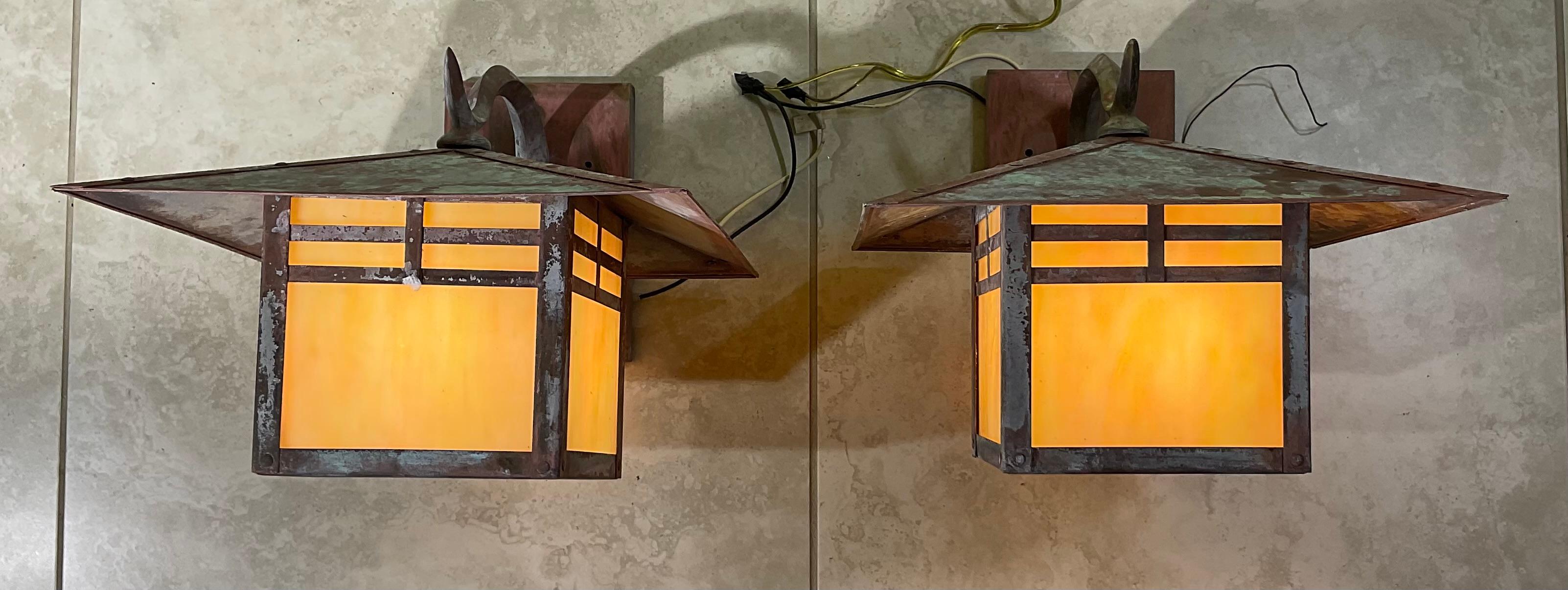 This  pair of wall lantern made of solid brass, nice architectural look industrial style , exceptional quality workmanship,  four side of art glass , beautiful patina ,electrified with one 100/watt light each,  . UL approved 
Suitable for wet