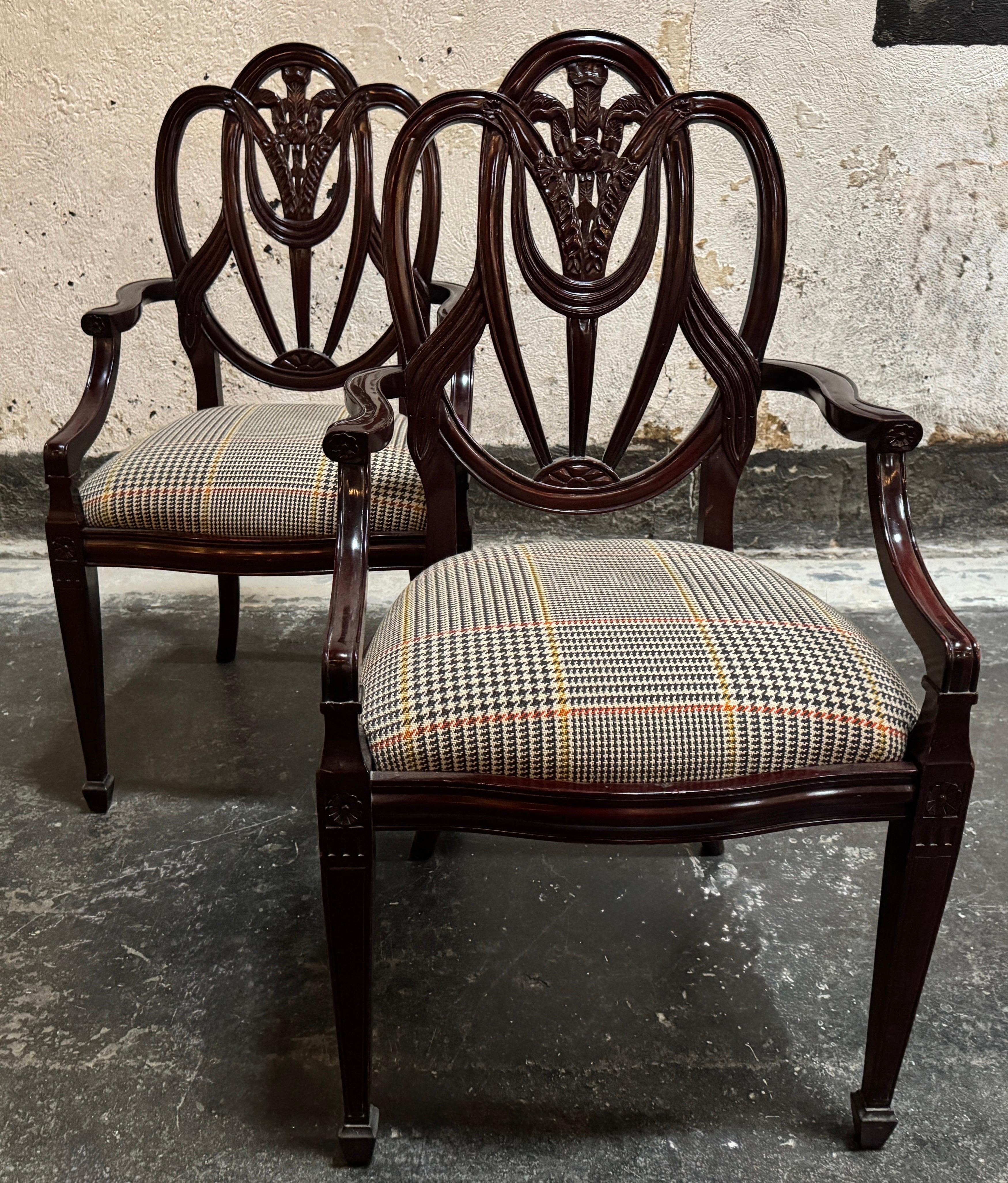 Exceptional pair of vintage armchairs (often referred to as “carvers”) that perfectly embody the refined taste of the Neoclassical/Federal Period, strongly influenced by the designs of George Hepplewhite.  High-quality reproductions from the 1990s,