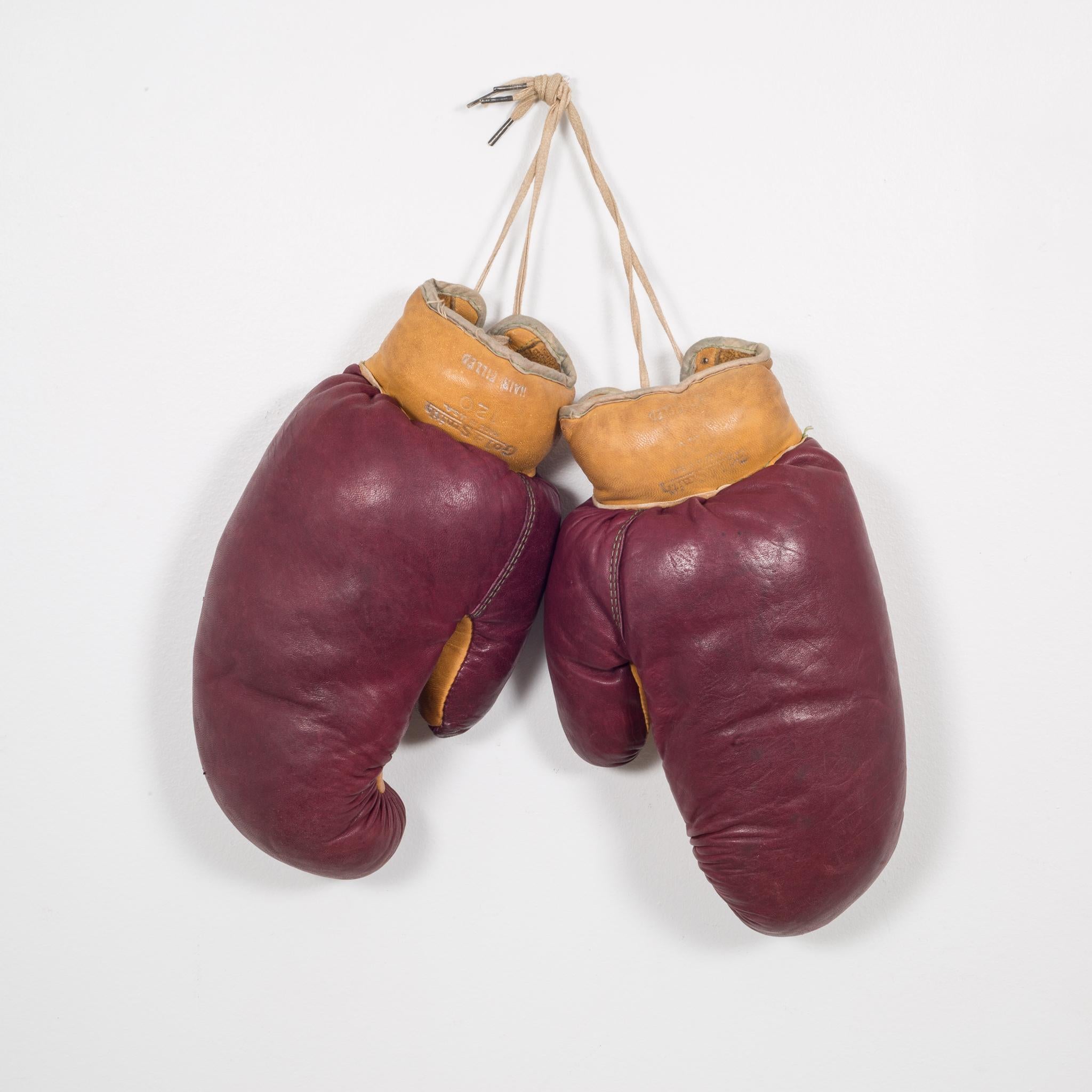 About

These are authentic vintage boxing gloves with reddish, brown leather and tobacco colored leather filled with horse hair. Each glove has green leather piping and tan laces. The leather is very soft and in good condition. Stamped 