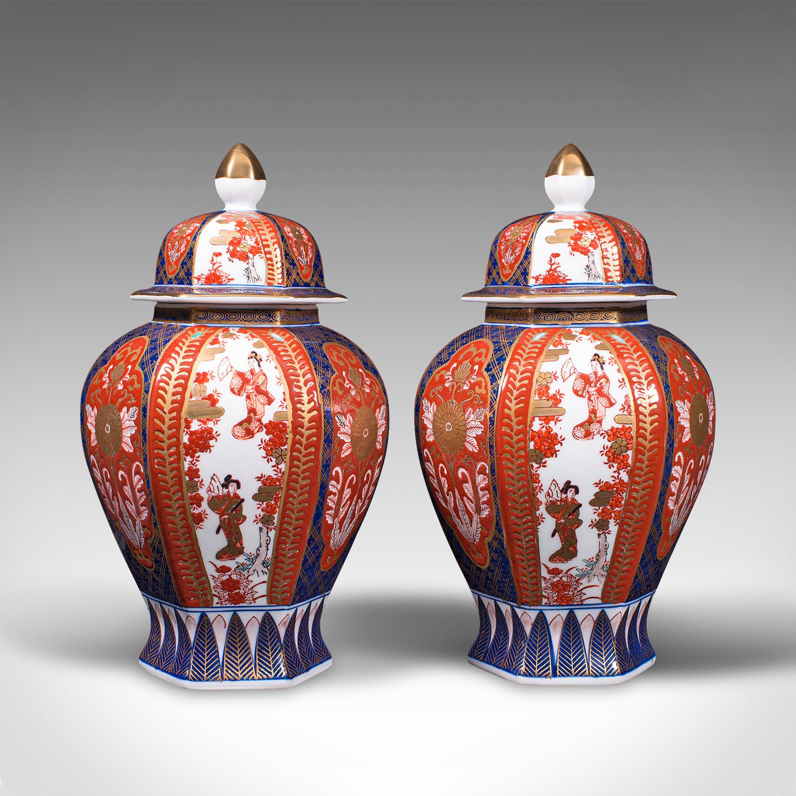 This is a pair of vintage Imari ginger jars. A Japanese, ceramic baluster urn with profusely hand painted decoration, dating to the late Art Deco period, circa 1940.

Of classic baluster form and in good proportion
Displaying a desirable aged