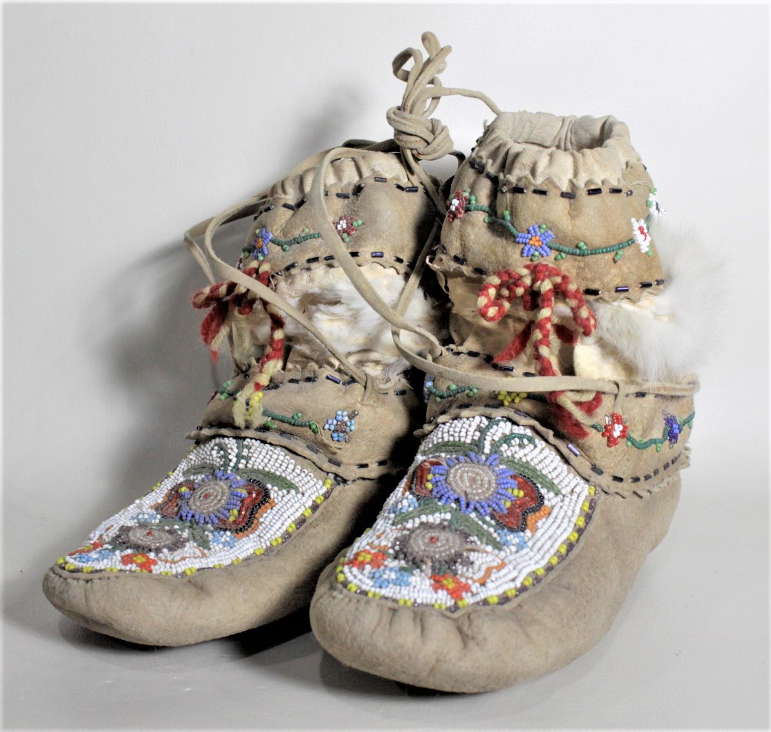 This pair of Indigenous American beaded boots are presumed to have been made in North America and in the United States, but it not known what Band they were made by. The boots are made completely of leather with brightly colored glass beaded