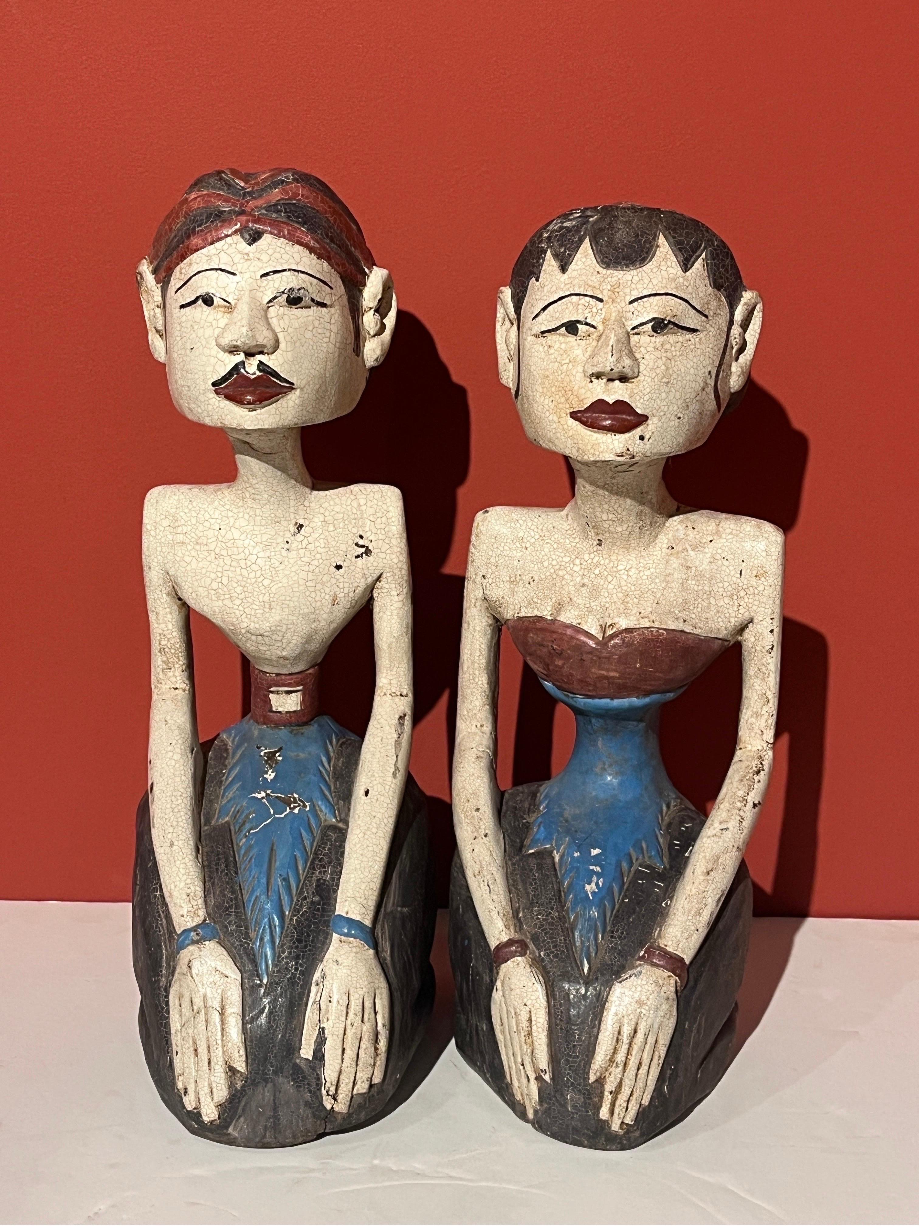 A mid 20th Century pair of hand carved and hand painted wedding figures from Java, Indonesia.  These are known as Loro Blonyo, the 