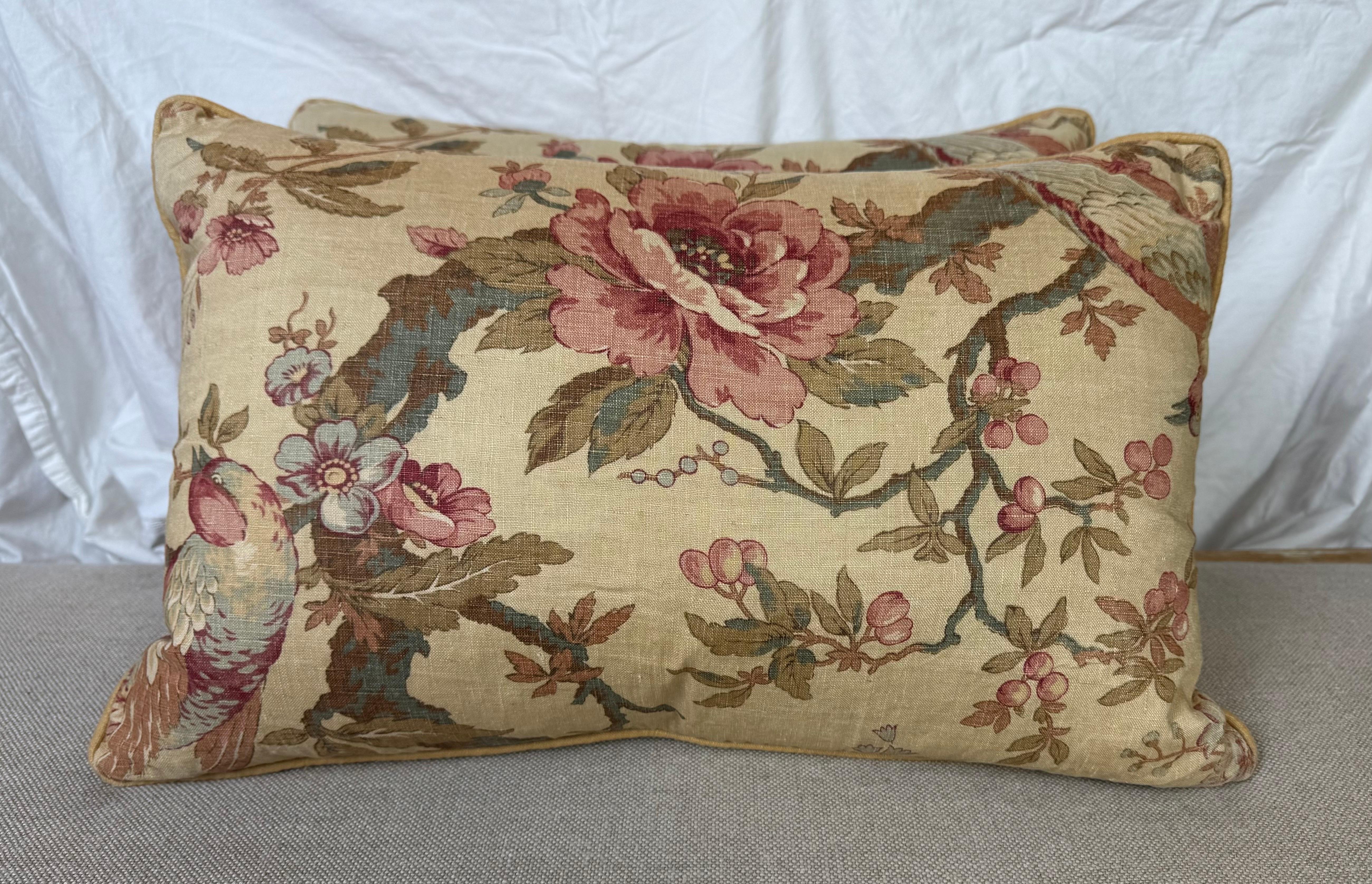 Questa coppia di cuscini lombari decorativi presenta un elegante disegno floreale in stile vintage su un caldo sfondo beige. Il disegno include rose splendidamente dettagliate nei toni del rosa intenso e del rosso, circondate da rami sinuosi, foglie