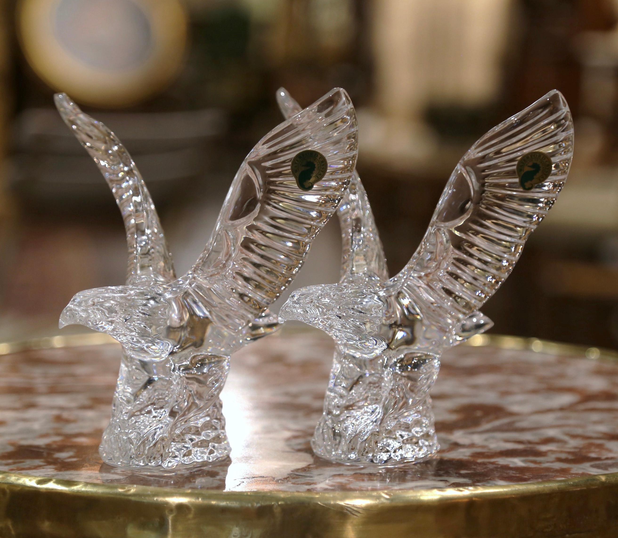 This set of intricately detailed flying bald eagles captured in clear and frosted crystal by Waterford were hand made in Ireland circa 1980. Each identical figurine features an elegant bird of prey with its wings stretched high and wide and its head