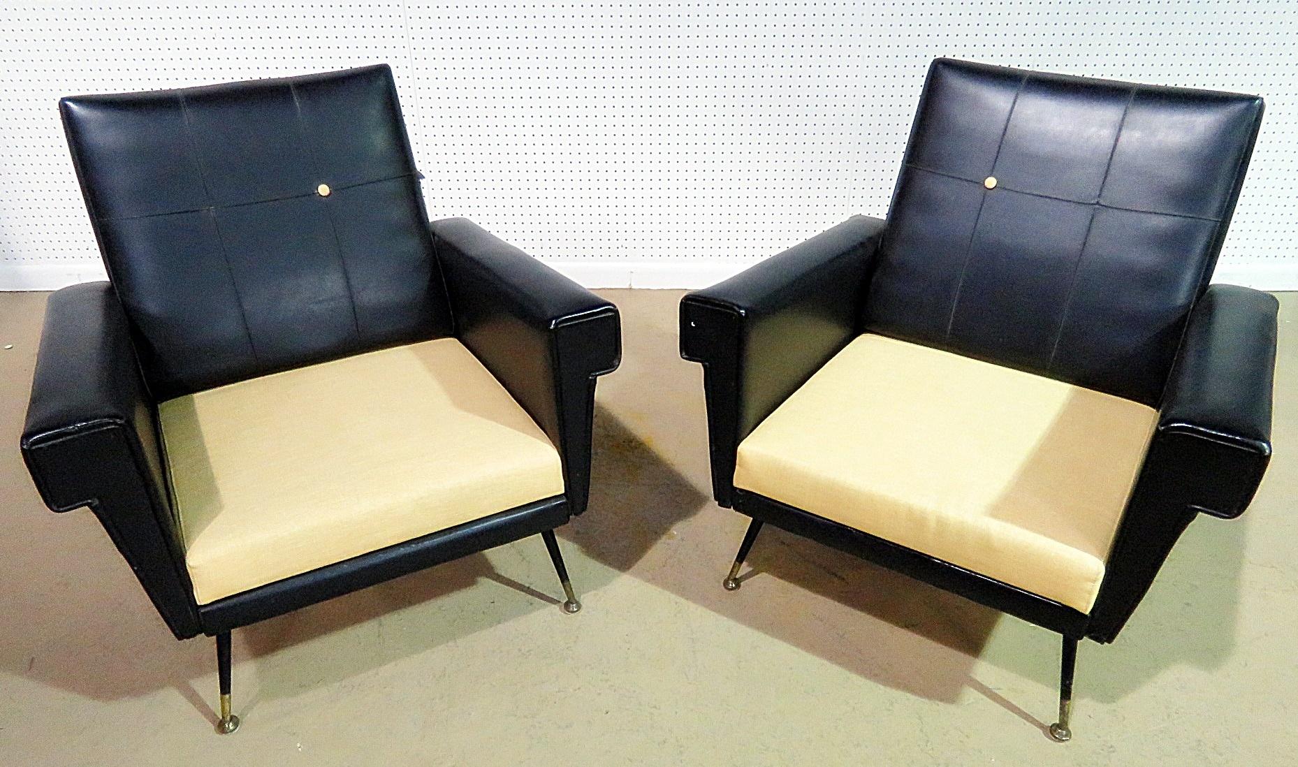 Pair of vintage Italian vinyl and fabric upholstered armchairs with metal legs and brass sabots.