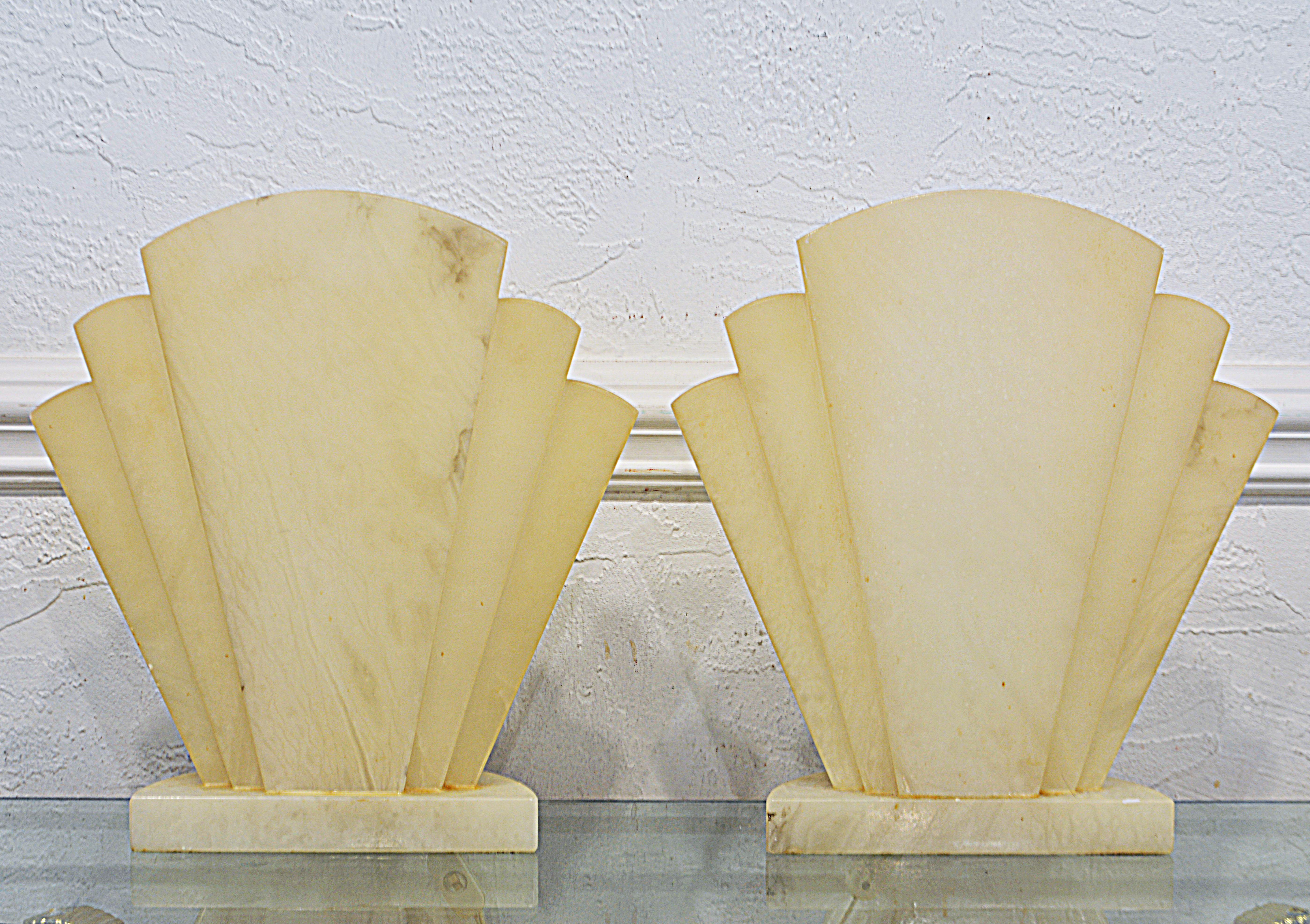 This pair of Art Deco style alabaster fan shape lamps reflects the essence of art deco. Branded with a Scaglione label, the alabaster is top quality. When lit they add an element of glamour to the surroundings.