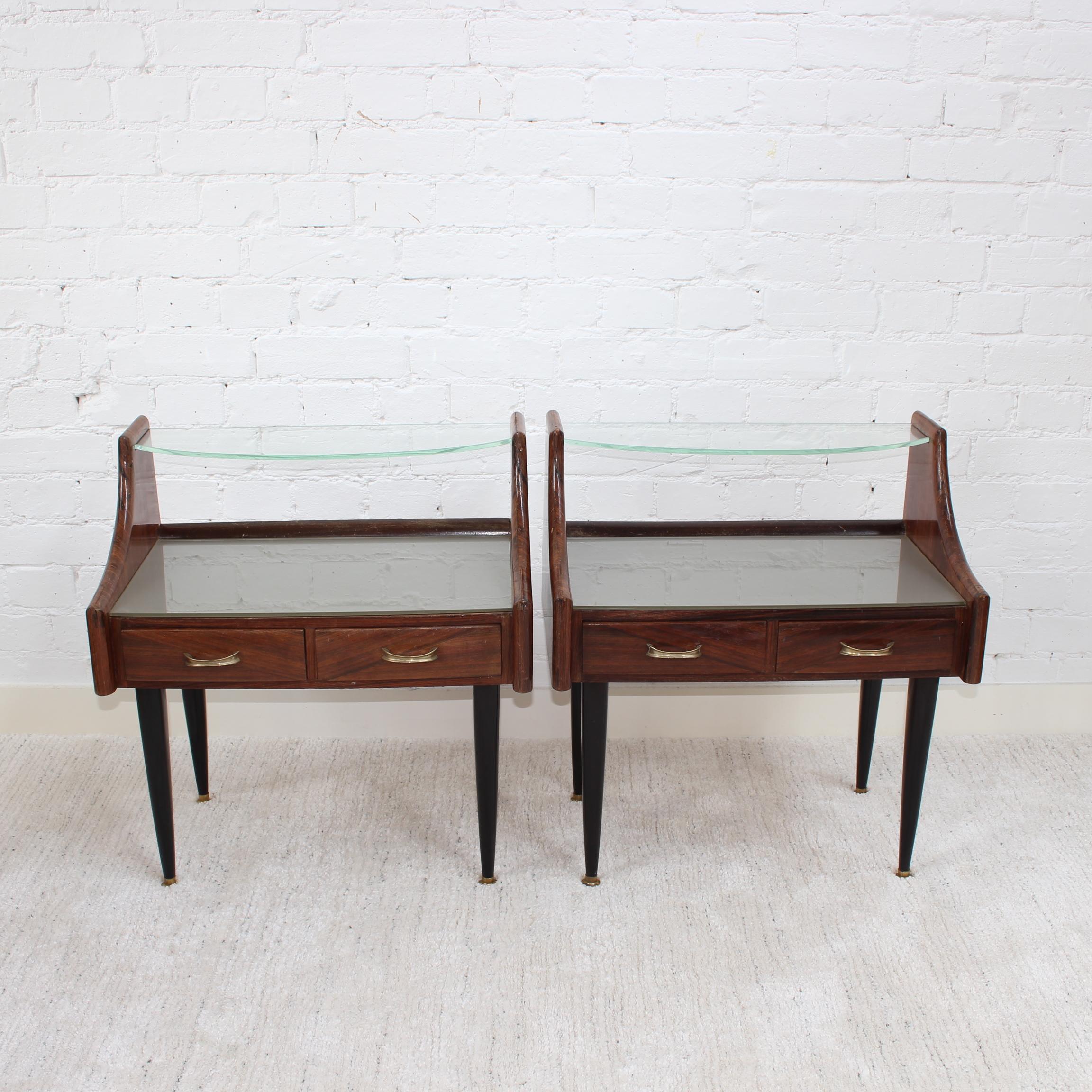 Pair of vintage Italian bedside tables, possibly by Ico Parisi (circa 1950s). Very stylish pieces with slews of character and charm. There are two horizontal surfaces for storage or display with the top made of glass and two small drawers with each