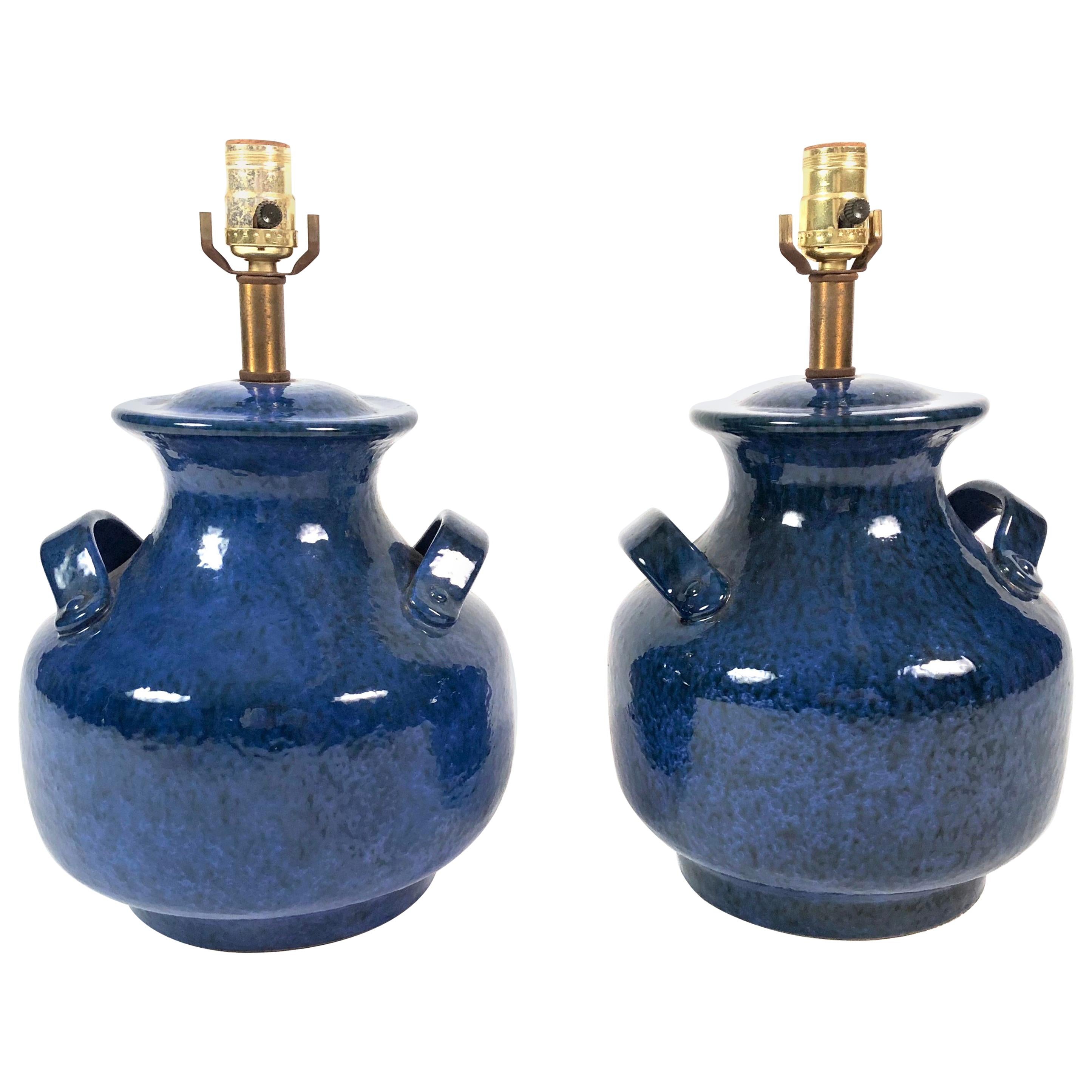 A pair of vintage Italian mottled blue glazed pottery lamps in the form of vases with strap handles on the shoulders, with brass neck. Overall height to top of shade (seen in last photo) is 24