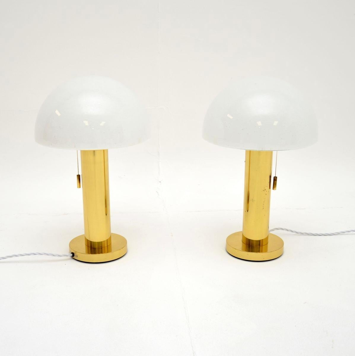A stunning pair of vintage Italian brass and glass table lamps, dating from the 1970’s.

They are of exceptional quality, the brass stands are beautifully made and support wonderful white opaque shades. They are a lovely size and look absolutely