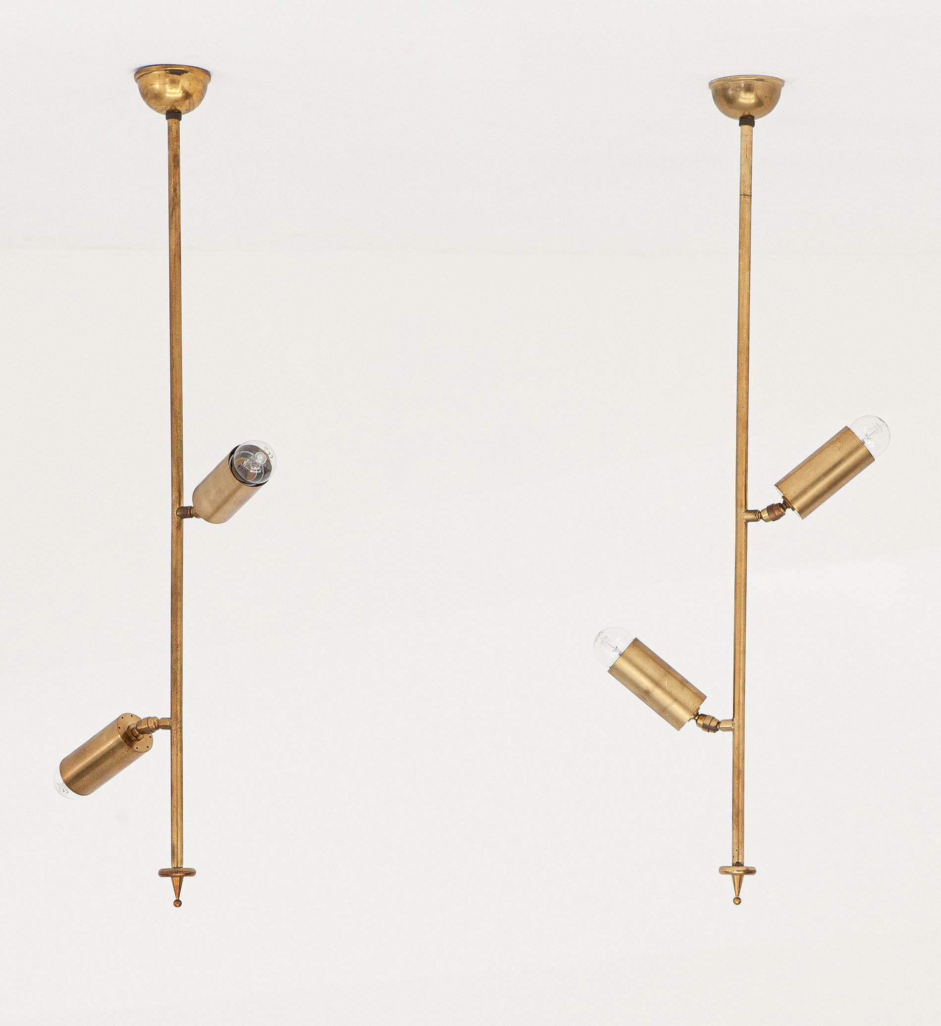 Pair of chandeliers in brass, Italy, 1950s. 

This set consists of two ceiling lamps with omnidirectional diffusers. 
They are entirely made of brass, with a beautiful original patina.