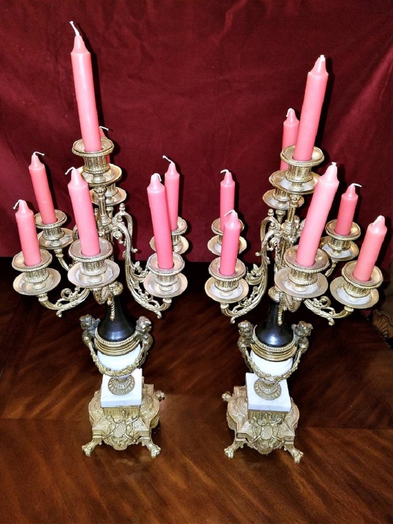 Gorgeous pair of vintage Italian Brevettato white marble and gilt brass candelabra or garnitures.

They were probably originally made in the mid-20th century as garnitures to accompany an Italian mantel clock.

They work perfectly however on