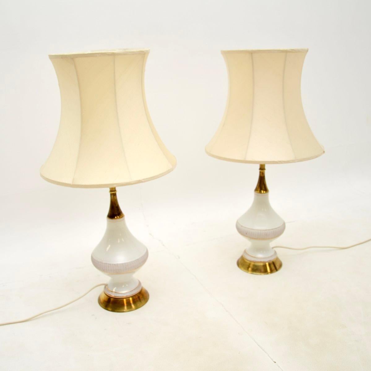 A stylish and very well made pair of vintage Italian ceramic and brass table lamps. They were made in Italy, and date from around the 1960’s.

They are beautifully designed, the white ceramic sections are hand painted with gold decorations, they