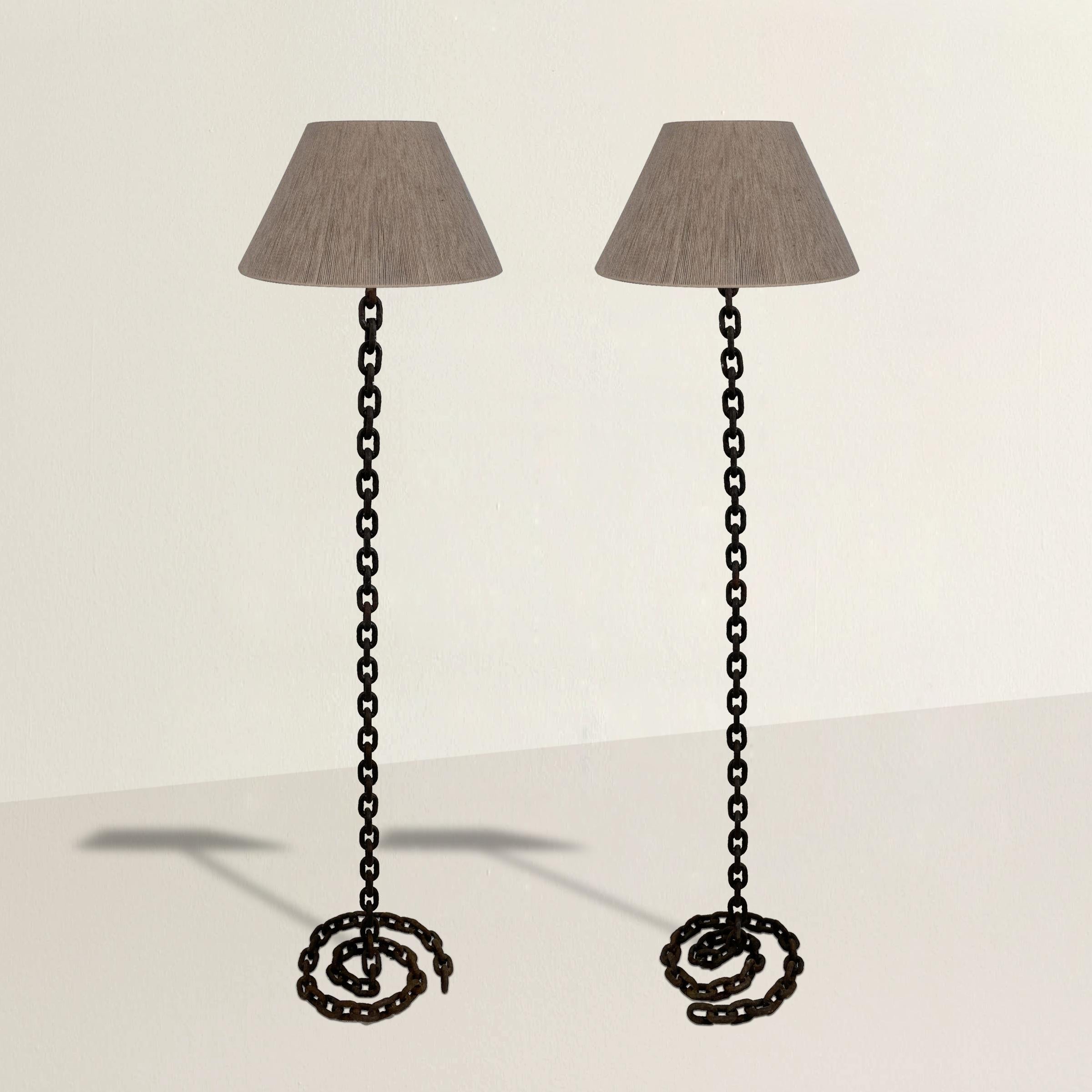 A bold and striking pair of mid-20th century Italian chain link floor lamps with coiled link bases and jute string shades. Lamps will be newly wired to your specifications upon purchase.