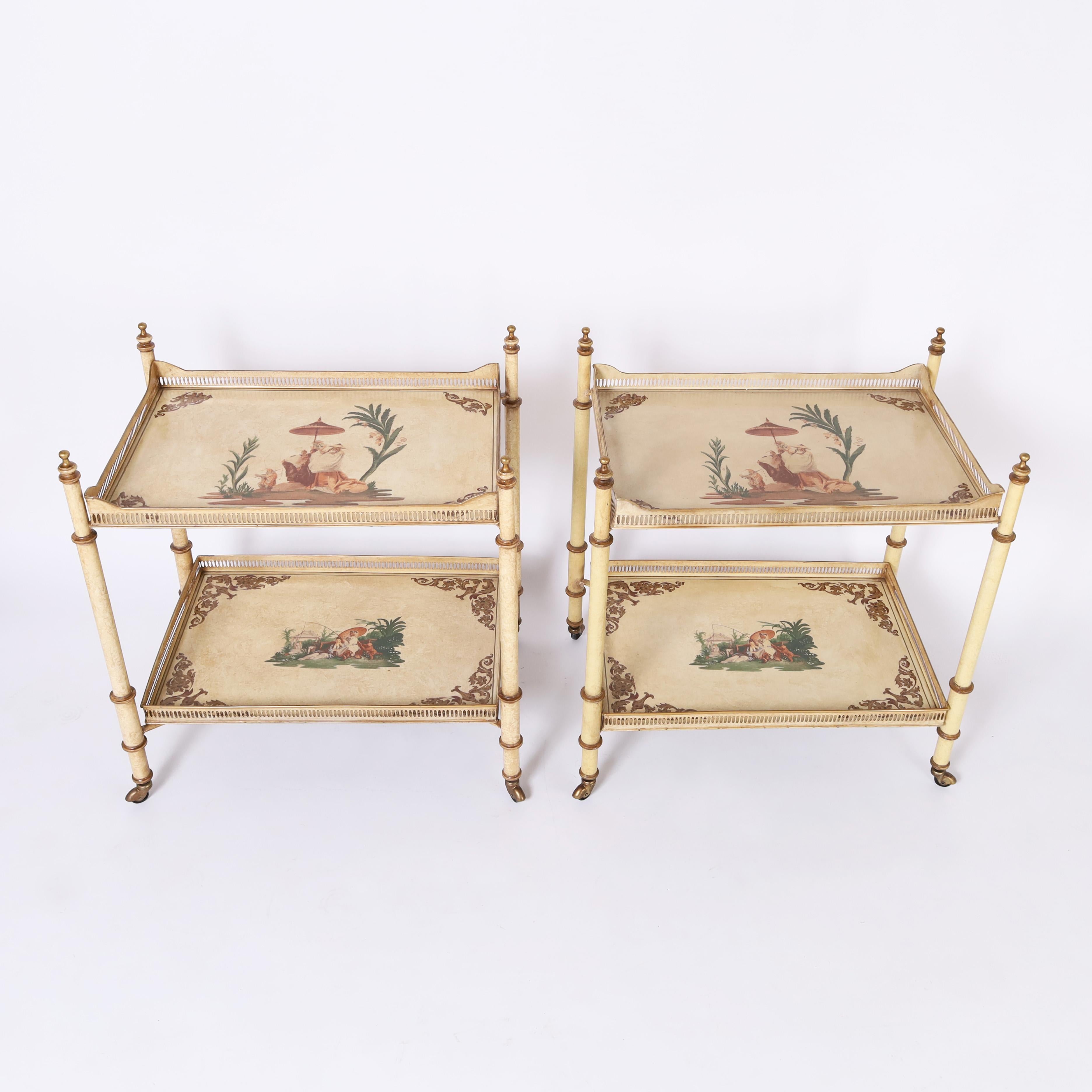 Chic pair of vintage Italian tole off white serving or bar carts having two tiers of removable trays, with galleries, decorated in Chinoiserie on faux bamboo supports with casters.