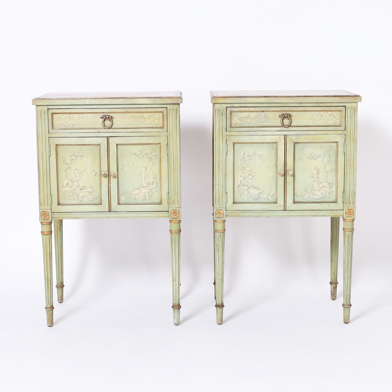 Charming pair of Italian stands crafted in hardwood with classic form, painted continental green and decorated in soft and subtle chinoiserie on the top sides and front over elegant fluted legs.