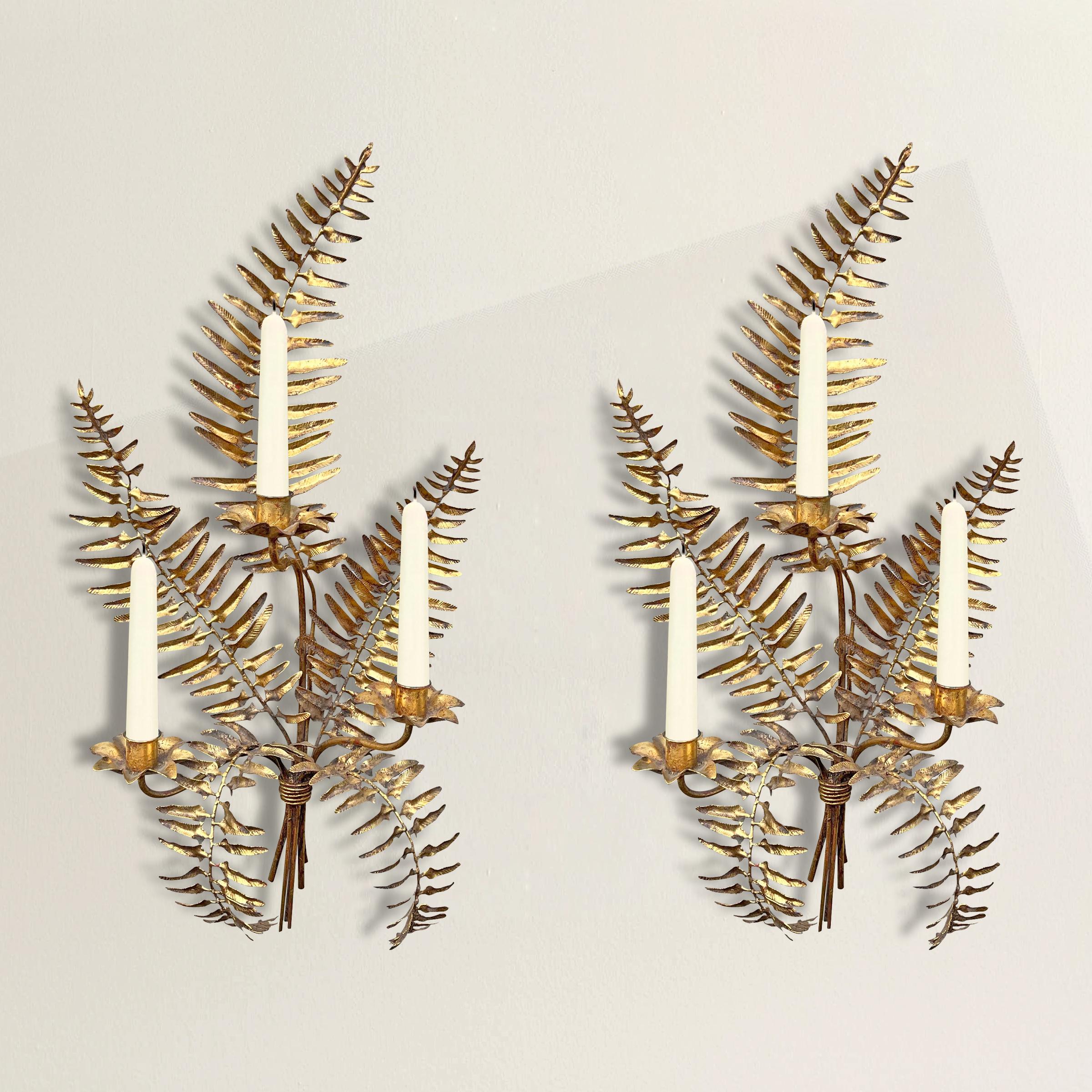 A whimsical yet chic pair of vintage Italian gilt fern candle sconces with a cluster of fern fronds tied at the bottom with string, and three arms with ruffled candle cups. Perfect flanking a mirror in your dining room, or have them electrified and