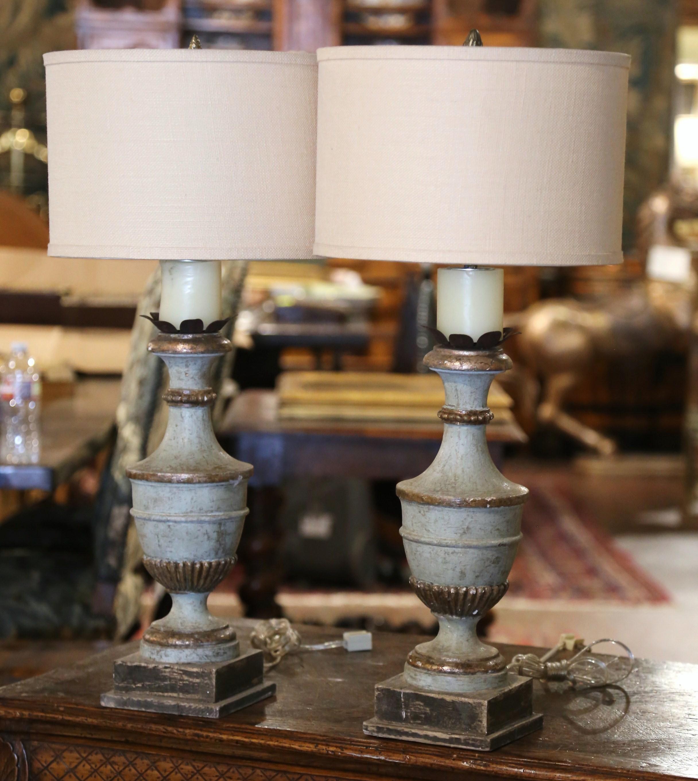 Incorporate extra light into a living room or bedroom with this elegant pair of colorful lamp bases. Crafted in Italy circa 2000, each lamp stands on an integral square base; the body is hand carved in the neoclassical urn-shape form, and