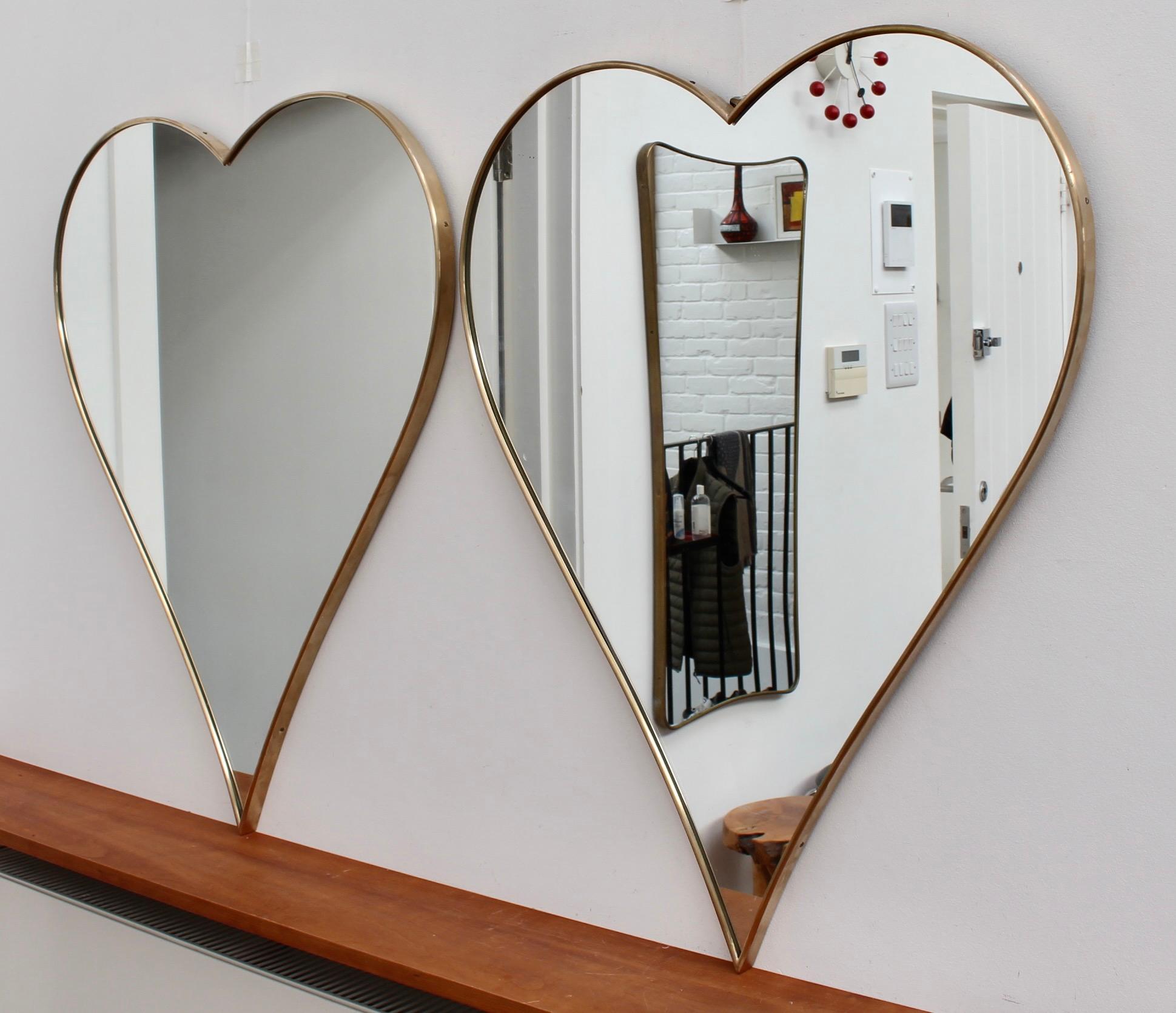 Pair of vintage Italian heart-shaped wall mirrors with brass frames (circa 1960s). What a gorgeous set of rare, heart-shaped vintage mirrors which are at the same time, classically elegant, yet modern in style. The mirrors are in very good overall