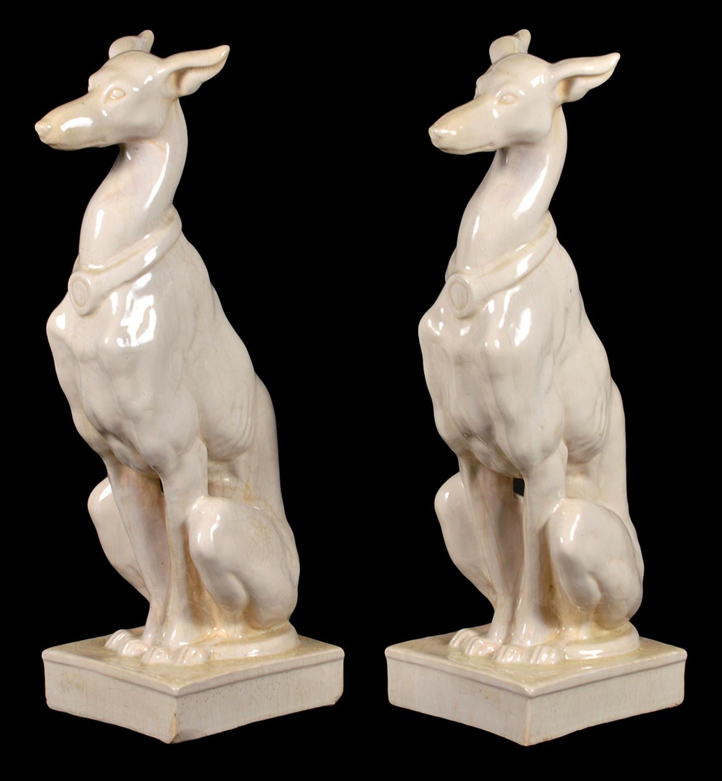 The two sitting dogs wearing collars are glazed with an off-white cracle glaze that compliments their graceful posture.