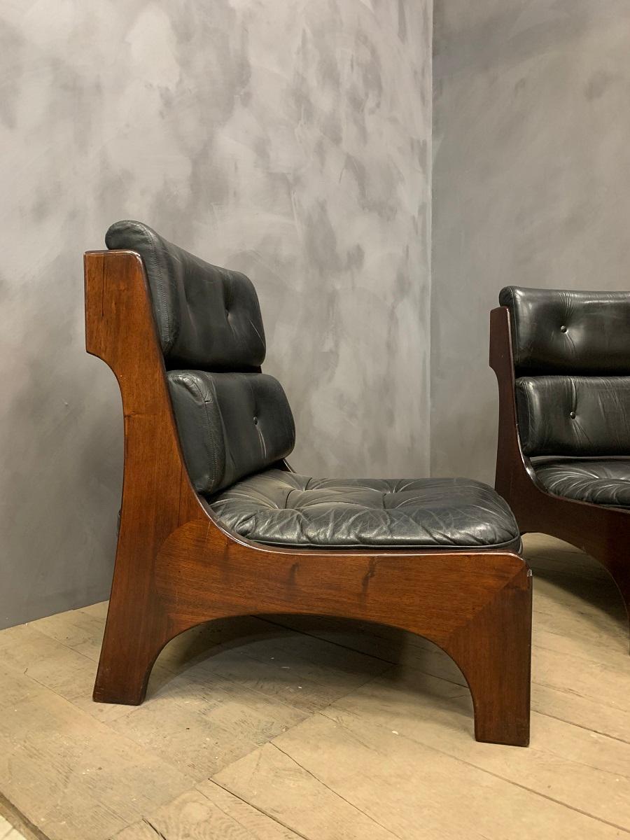 A high quality pair of Italian lounge chairs, circa 1970. Hand assembled in solid rosewood and leather these chairs resonate stylish Italian craftmanship and design.