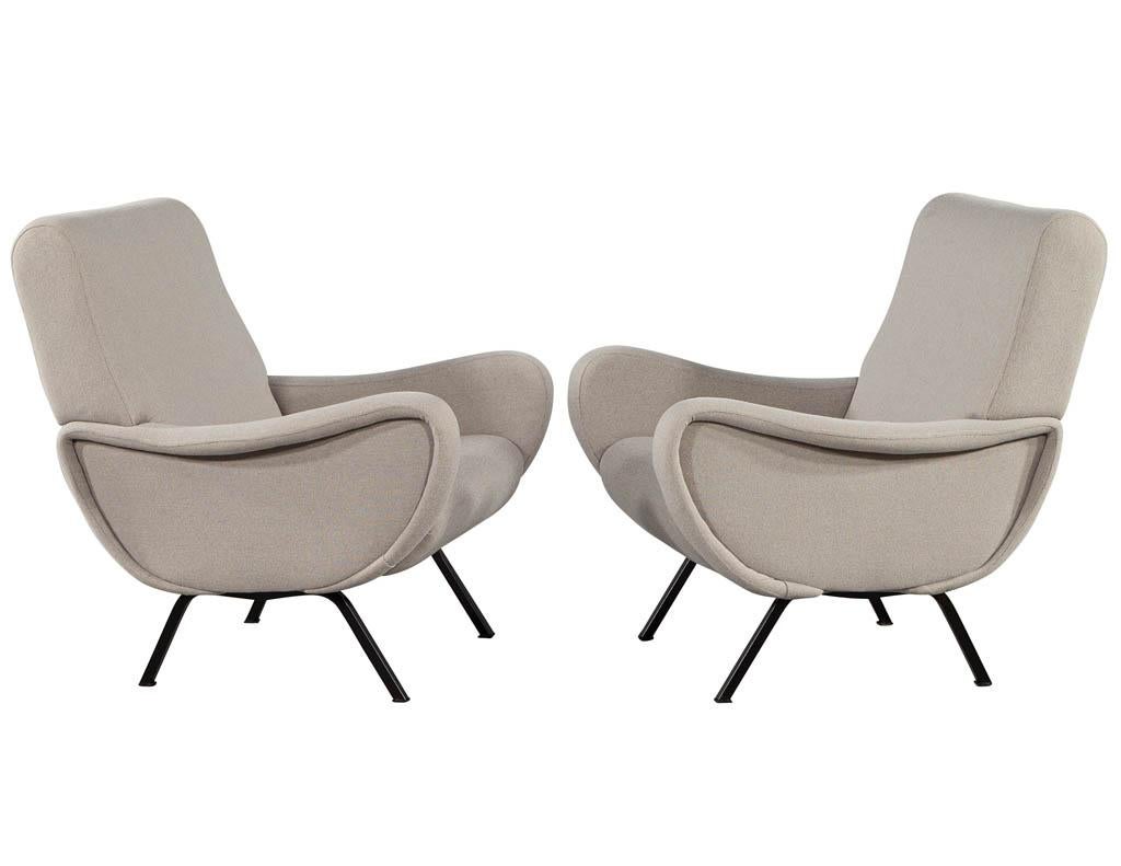 Pair of vintage Italian lounge chairs in the style of Zanuso. Italy, circa 1970's with original mid-century modern design. Upholstered in a designer light grey covering. All original in good condition.

Price includes complimentary curb side