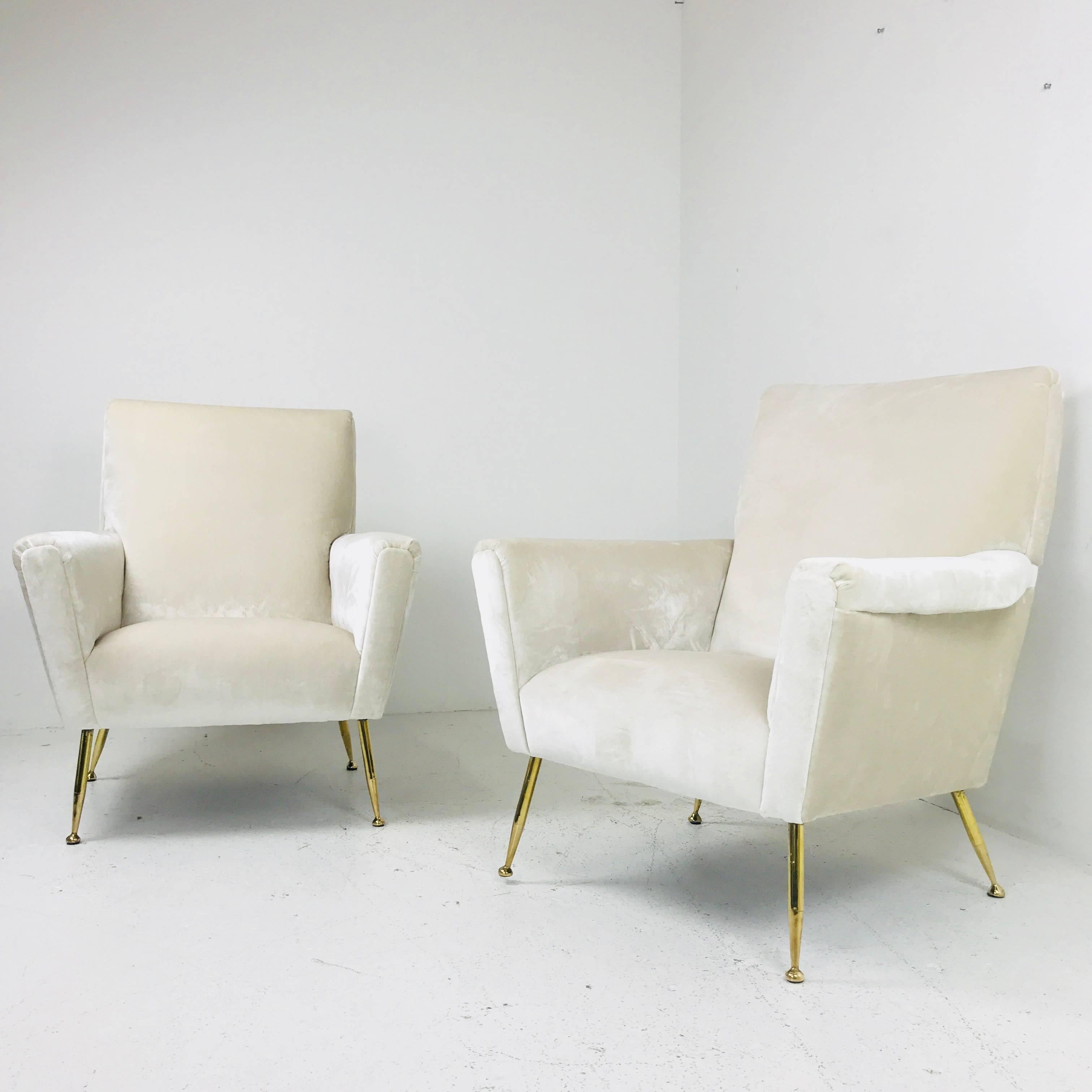 Pair of vintage Italian lounge chairs. Newly upholstered in a cream colored velvet. There is visible wear on the legs finish and recommenced refinishing.

dimensions: 33