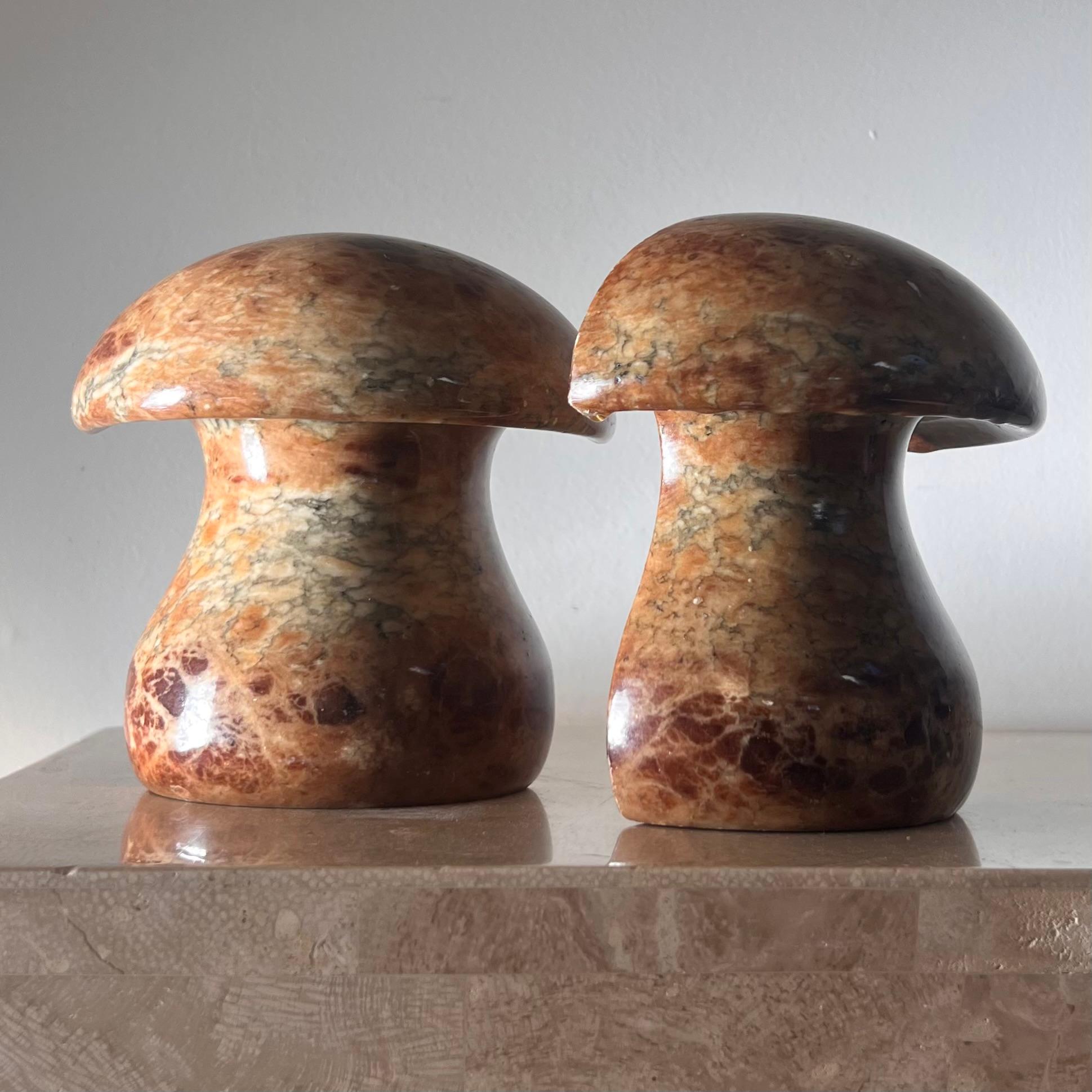 A pair of vintage Italian alabaster marble mushroom bookends, hand-carved in Volterra circa mid 1960s. Tones of chestnut, pewter, and caramel. Some wear consistent with age and use but no glaring flaws. Pick up in central west Los Angeles or we ship