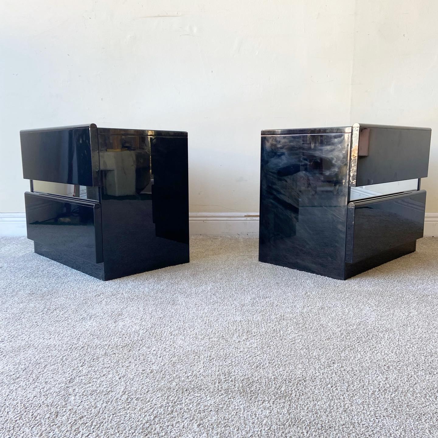 Amazing pair of Italian black lacquered nightstands. Each features two stations drawers with a mirror panel between them and a mirrored top.

Additional Information:
Material: Mirror, Wood
Color: Black
Style: Italian, Postmodern
Time Period: