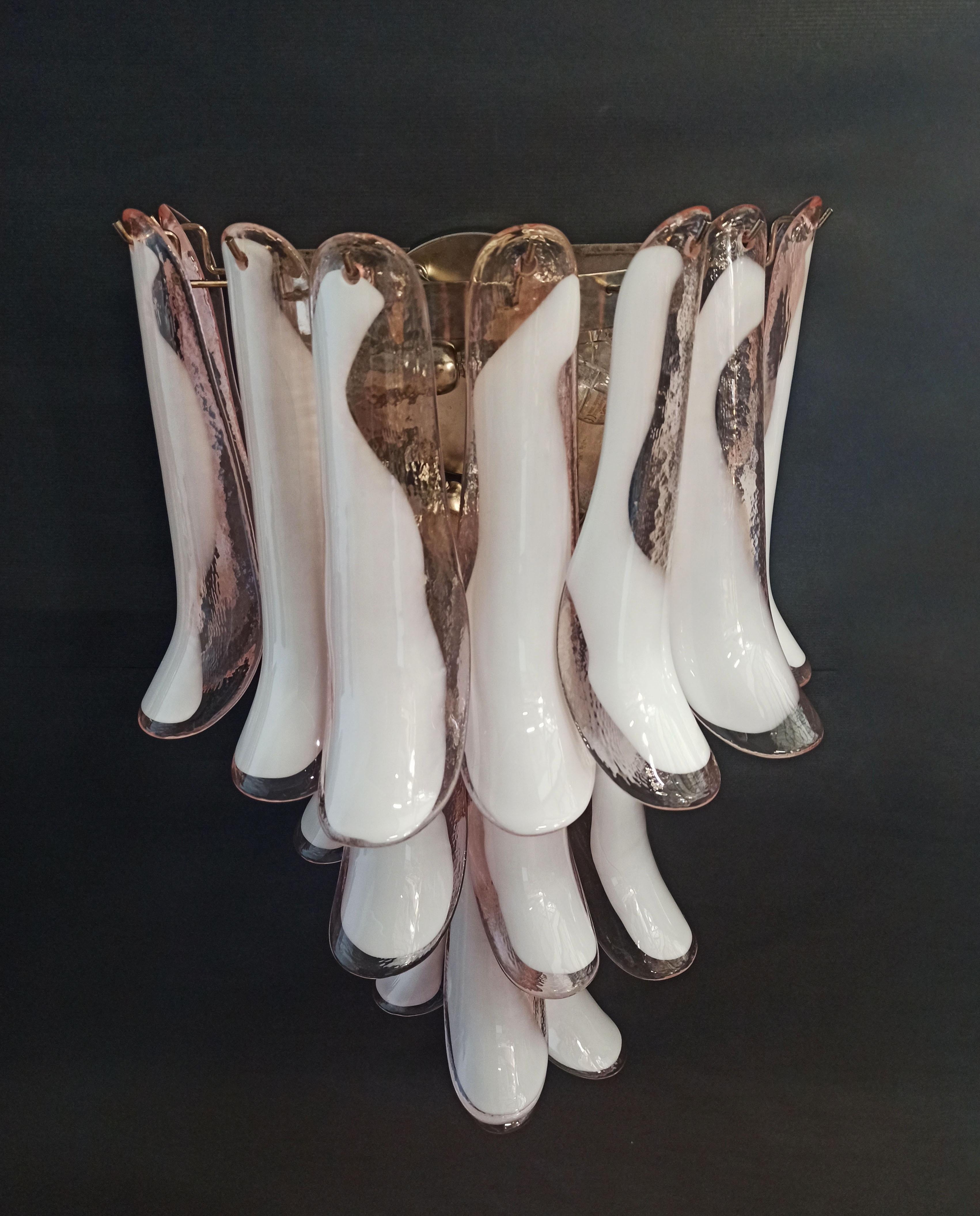 Pair of Vintage Italian Murano wall sconces. Wall lights have 16 pink and white“lattimo” glasses (for each applique) in a nickel-plated metal frame. Decorative object of great importance.
Period: late XX century
Dimensions: 27,90 inches (72 cm)