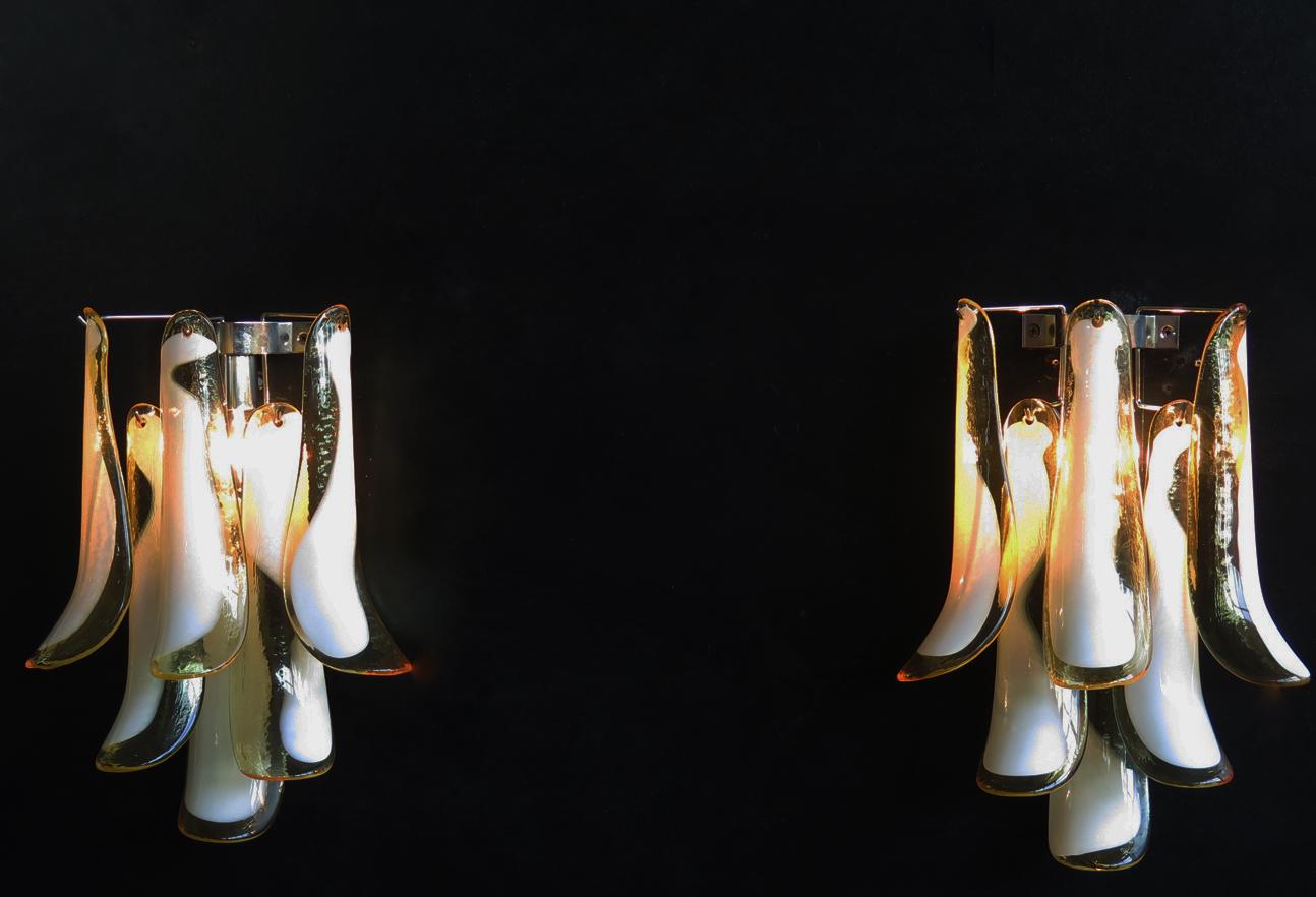 Pair of vintage Italian Murano appliques. Wall lights have 6 caramel and lattimo glass petals (for each applique) in a chrome frame.
Period: 1970s
Dimensions: 17.30 inches (44 cm) height, 13 inches (33 cm) width, 7.10 inches (18 cm) depth from the
