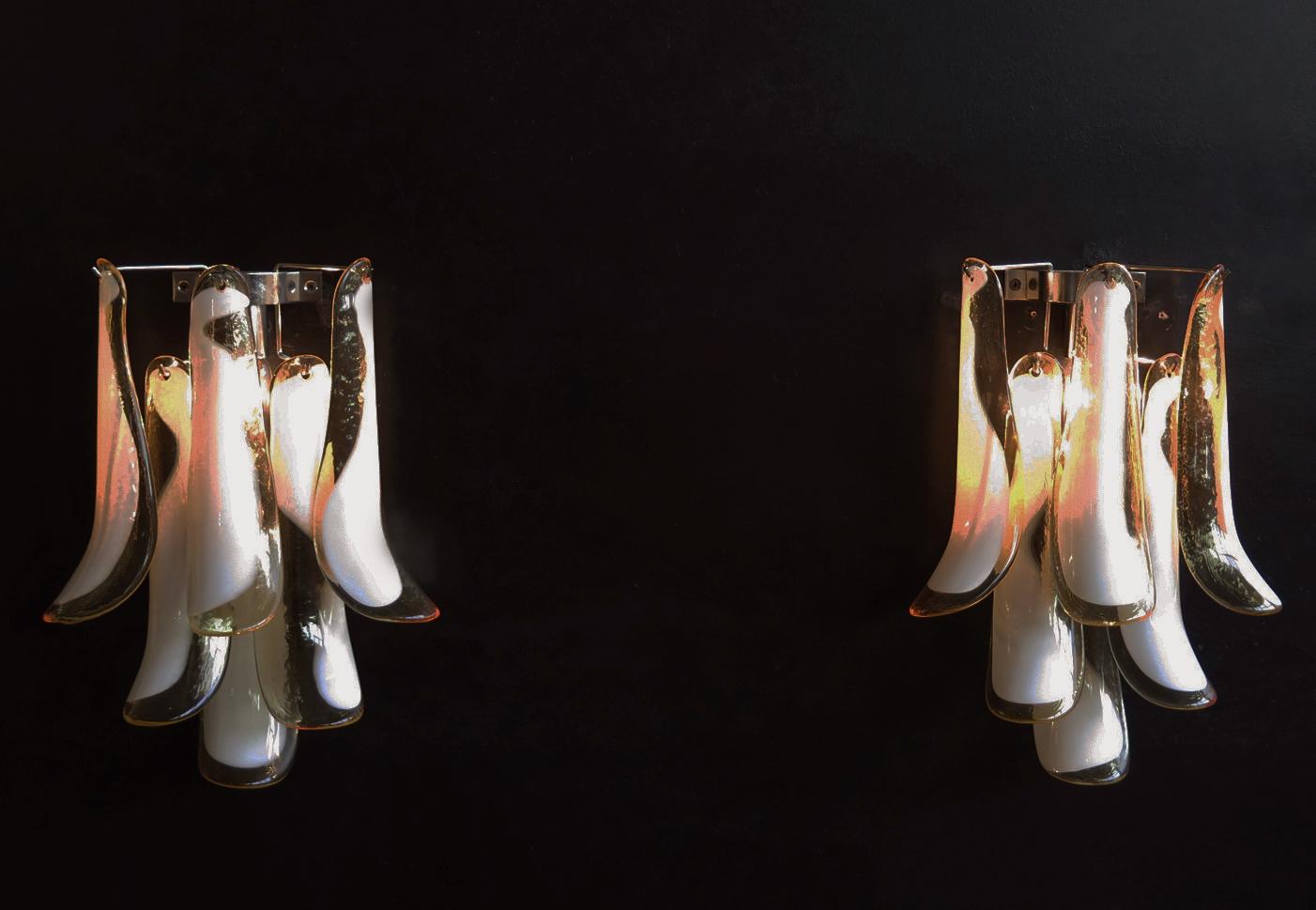 Pair of vintage Italian Murano appliques. Wall lights have 6 caramel and lattimo glass petals (for each applique) in a chrome frame.
Period: 1970's
Dimensions: 17,30 inches (44 cm) height; 13 inches (33 cm) width; 7,10 inches (18 cm) depth from