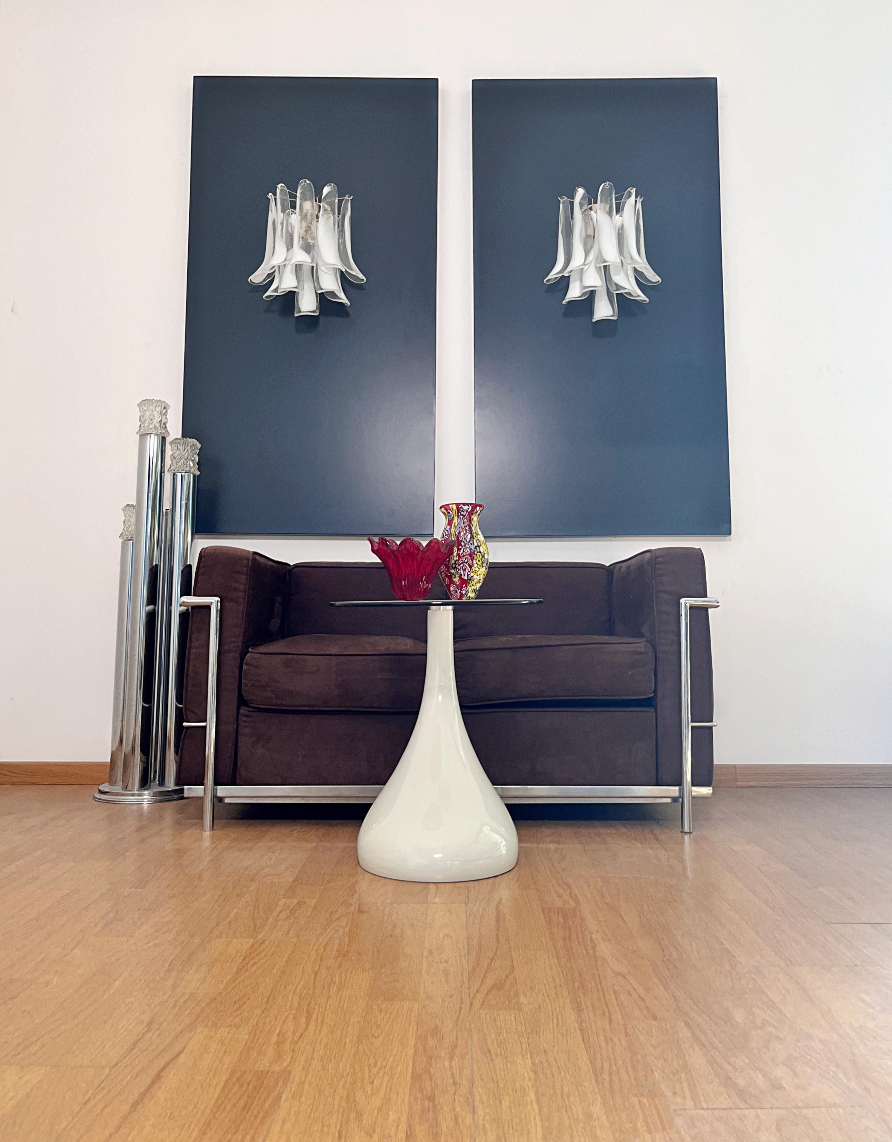 Pair of Vintage Italian Murano appliques in the manner of Mazzega . Wall lights have 10 trasparent lattimo glass petals (for each applique) in a chrome frame.
Period: late XX century
Dimensions: 16,50 inches (42 cm) height; 13,80 inches (35 cm)