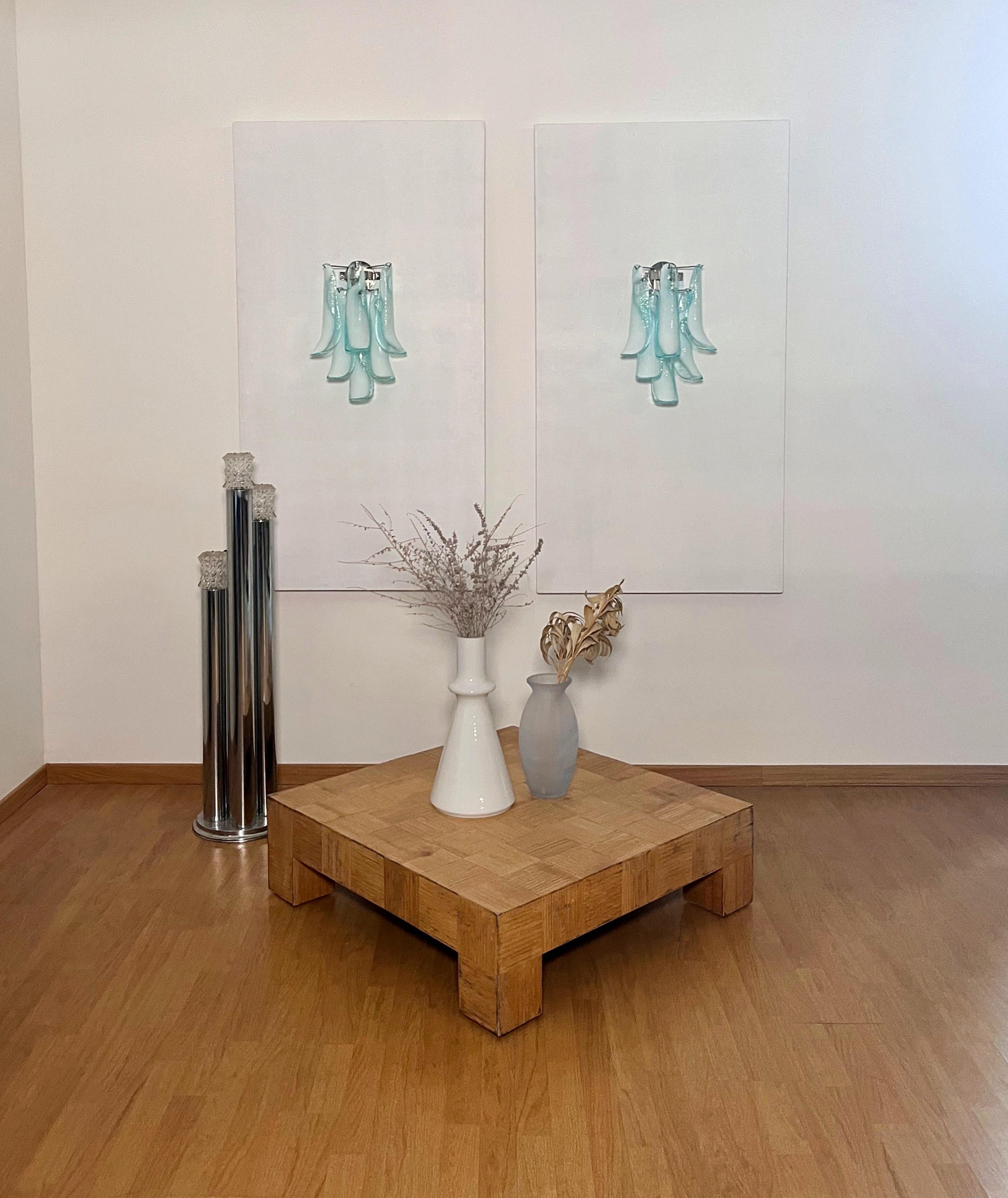 Pair of Vintage Italian Murano appliques. Wall lights have 6 turquoise and lattimo glass petals (for each applique) in a chrome frame.
Period: late 20th century 
Dimensions: 18.60 inches (48 cm) height; 12 inches (31 cm) width; 7.75 inches (20 cm)