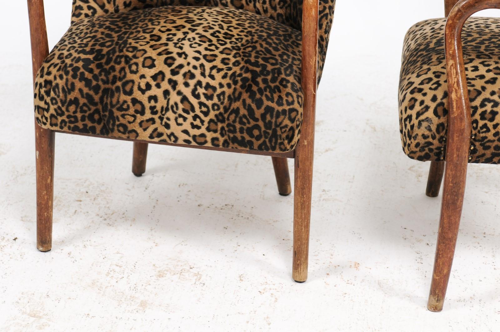 A pair of Italian vintage oak armchairs from the mid-20th century, with original leopard fabric. Full disclosure, our buying of these chairs, from a vendor in Italy, could have ended badly, with a few other buyers chasing after us to buy them from