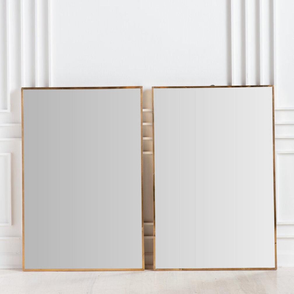 A pair of Italian brass mirrors in an easy rectangular shape. Available to purchase individually.