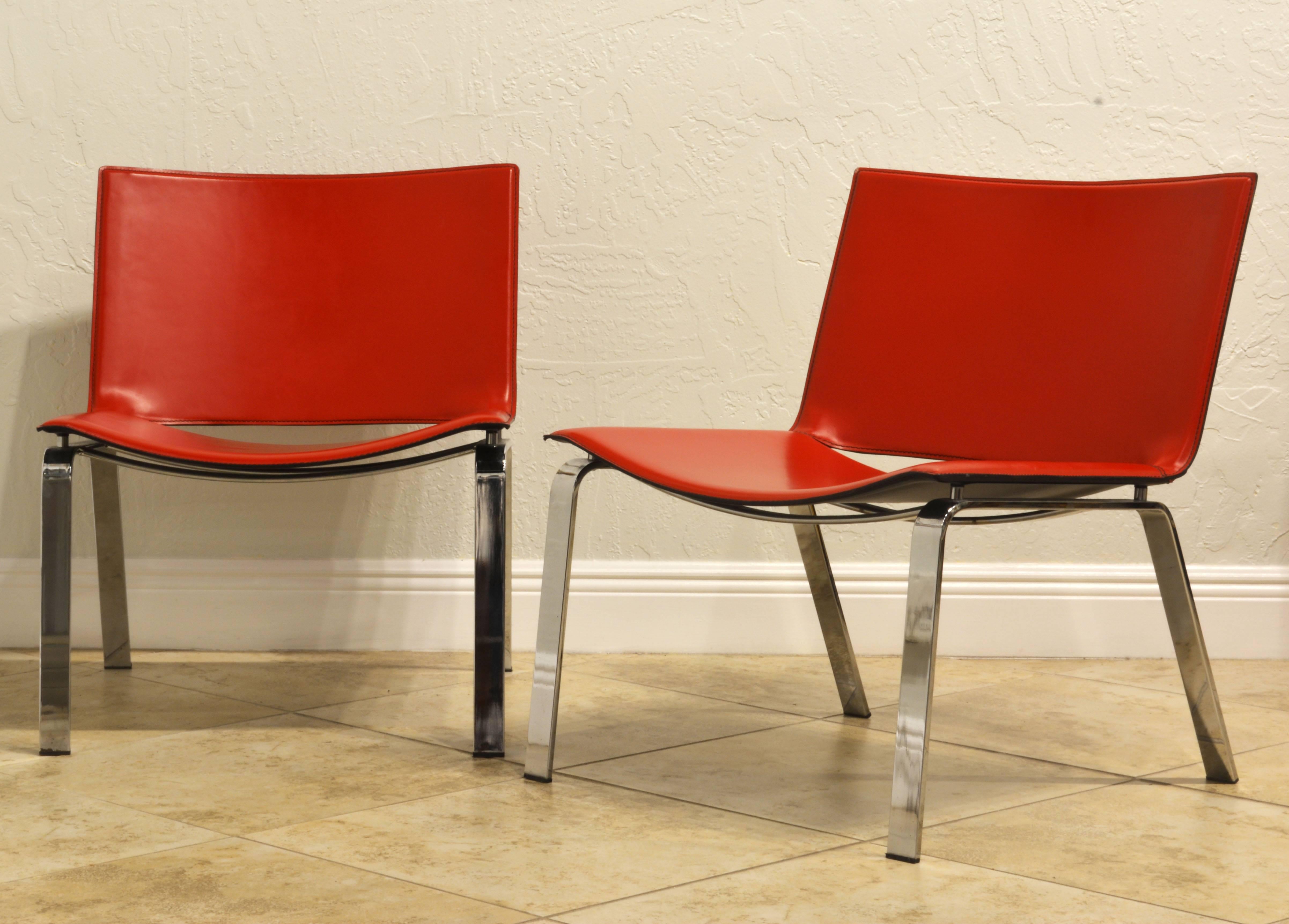 Sometimes less is more. This pair of early lounge chairs by Cattelan Italia represent modern and timeless design at its best. They feature red leather covered shell shaped backs and seats floating on one piece angled chrome steel legs. The chairs