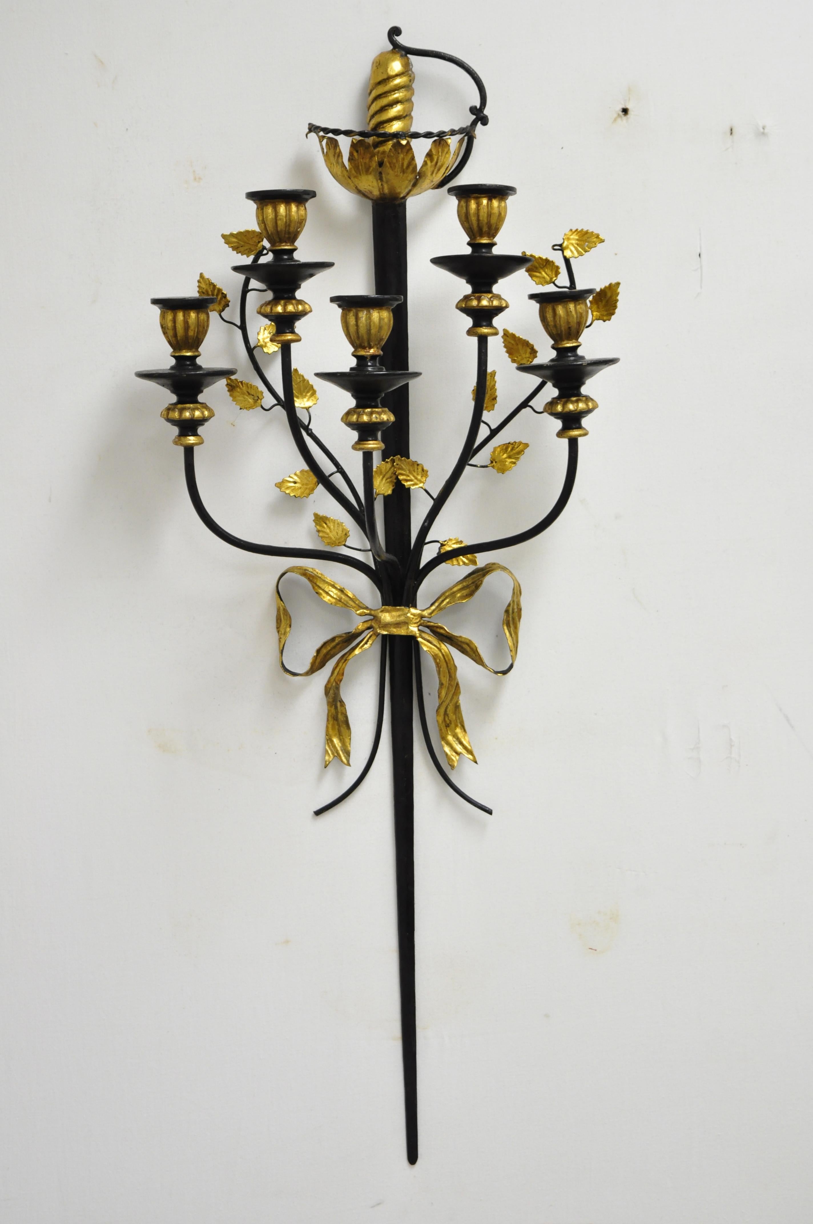 Pair of vintage Italian regency black and gold iron tole sword candle wall sconces. Listing includes long stately sword forms, 5 candleholders, black and gold gilt finish, very nice vintage item, quality Italian craftsmanship, circa mid-20th