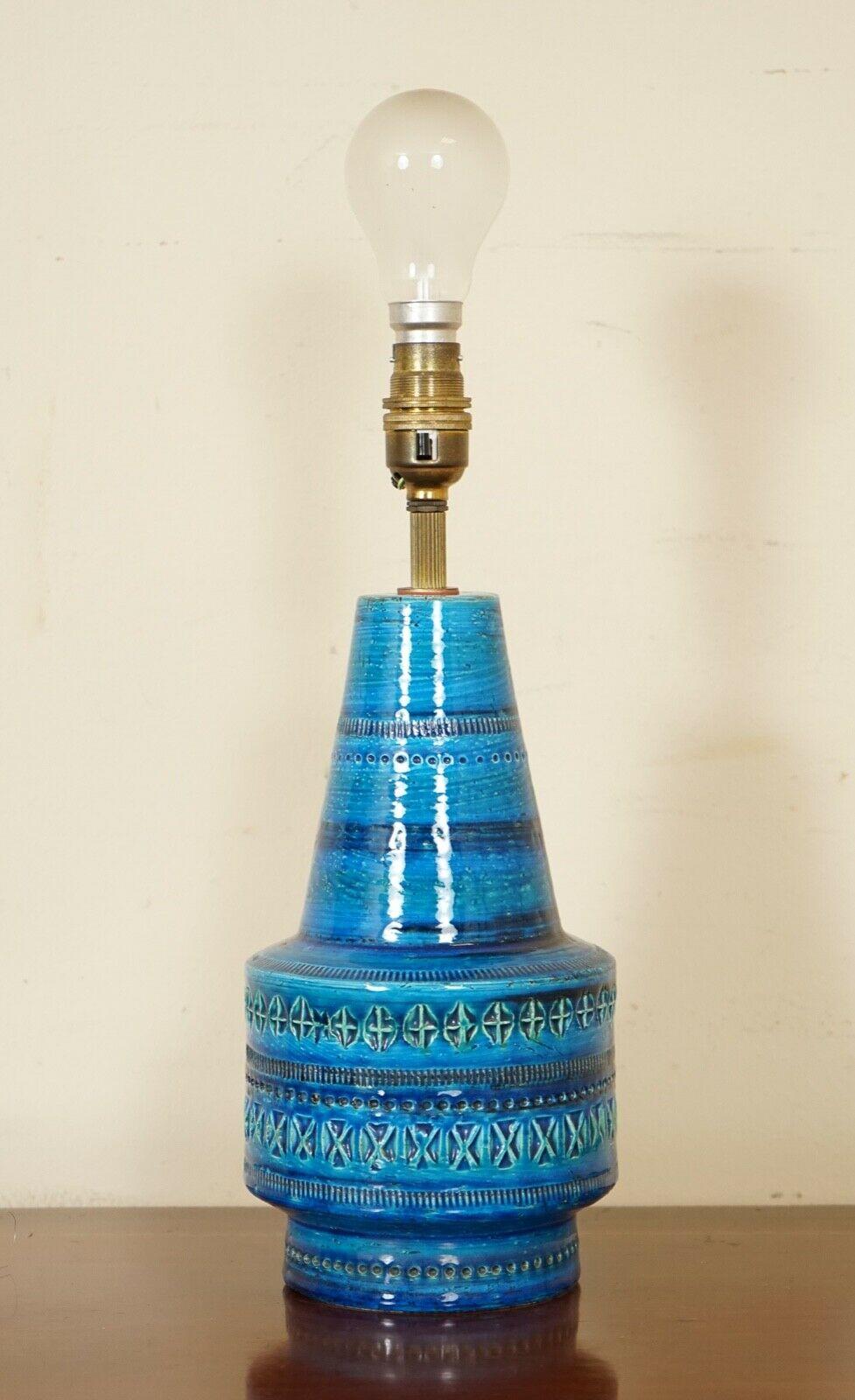 We are so excited to present to you this Rimni blue ceramic table lamp.
The rich colours of blue and turquoise make it such a stunning piece.
It is signed to be made in Italy on the bottom.

The lamp itself comes with a plug for the UK,
 if you