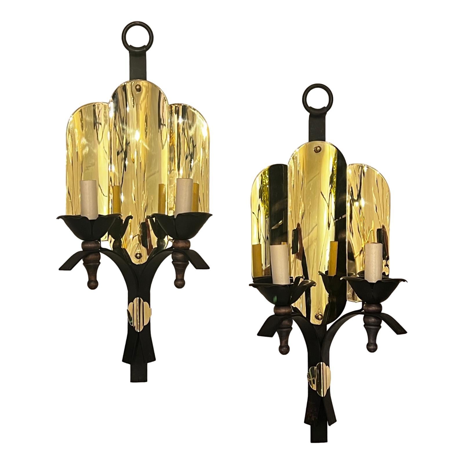 A pair of circa 1940's Italian polished bronze and iron two-light sconces with original patina.

Measurements:
Height: 20.5