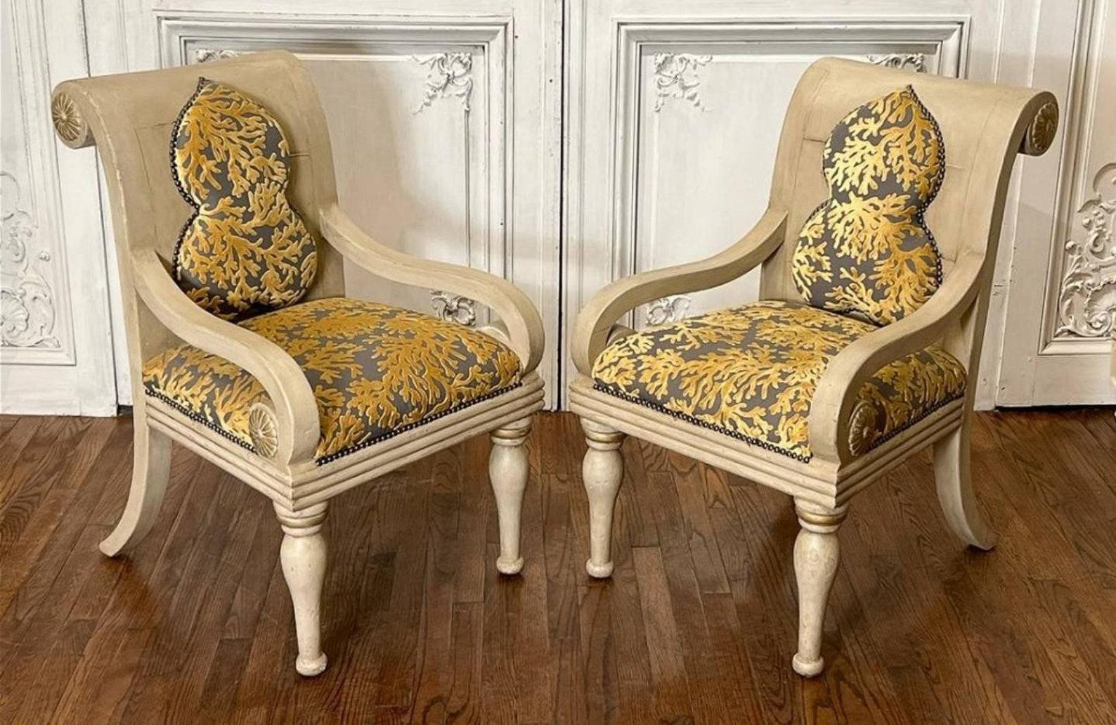 A stunning one-of-a-kind pair of hand carved and painted antique Italian Neoclassical rollback scrolled arm chairs completely restored in contemporary 21st century styling with a modern Anglo-Indian taste. Each chair featuring an overflowing scroll