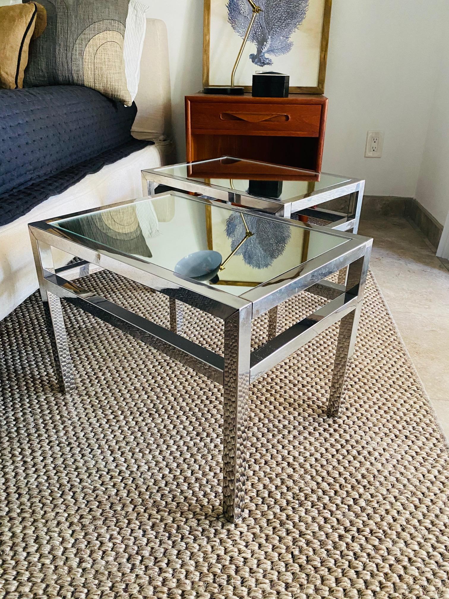 Pair of Italian Mid-Century Modern small side tables with industrial style frames. The tables have minimalist rectangular frames featuring double crossbar design in chrome metal fitted with mirrored tops. Streamline design makes these an elegant