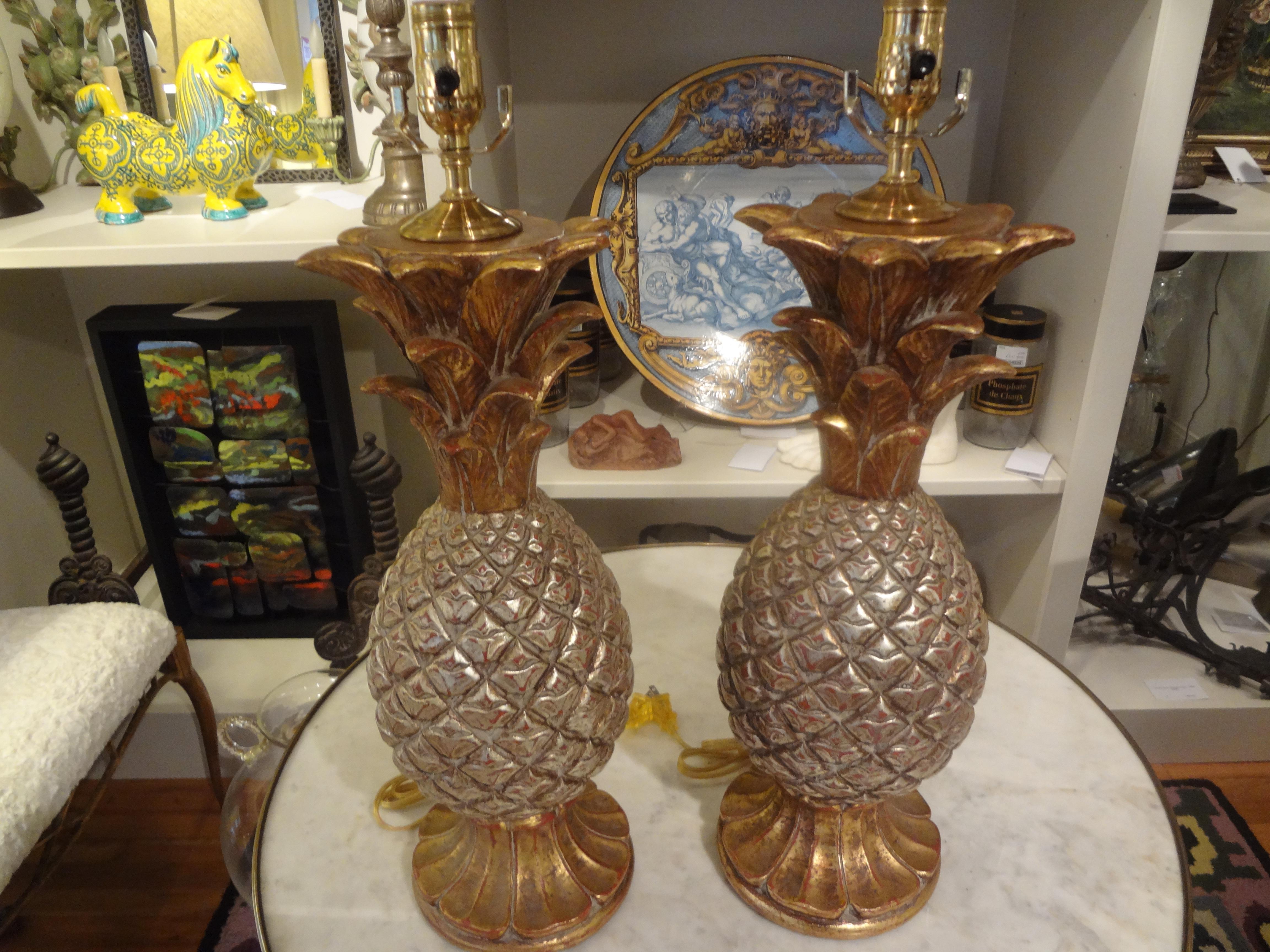 Pair of vintage Italian gilt terracotta pineapple lamps.
Stunning pair of midcentury Italian terracotta pineapple lamps. This pair of vintage Italian pineapple lamps are expertly executed in silver and gold leafed terracotta. This pair of Hollywood