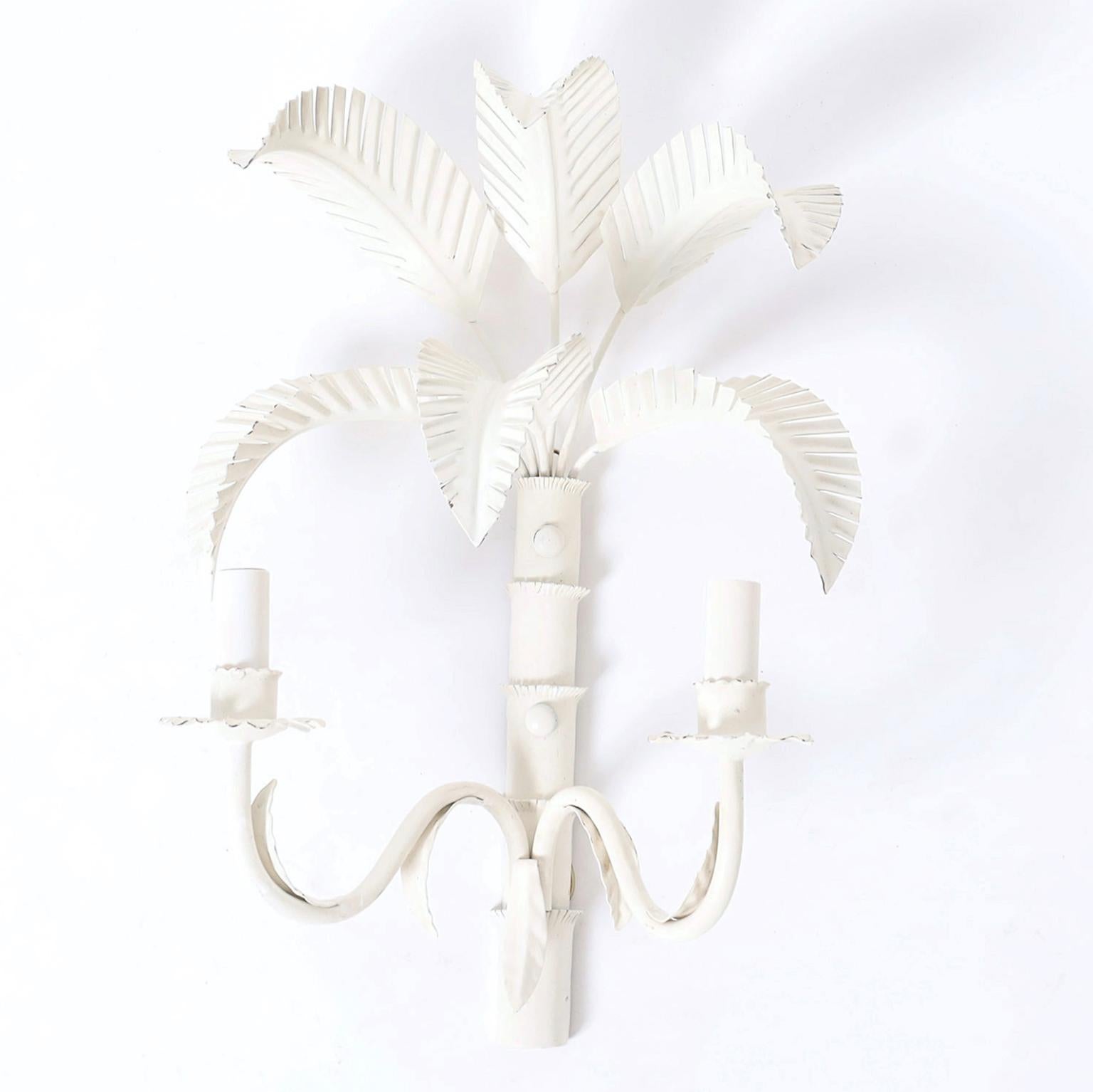 Pair of mid century two light wall sconces crafted in metal with a chic white painted finish over stylized palm trees.