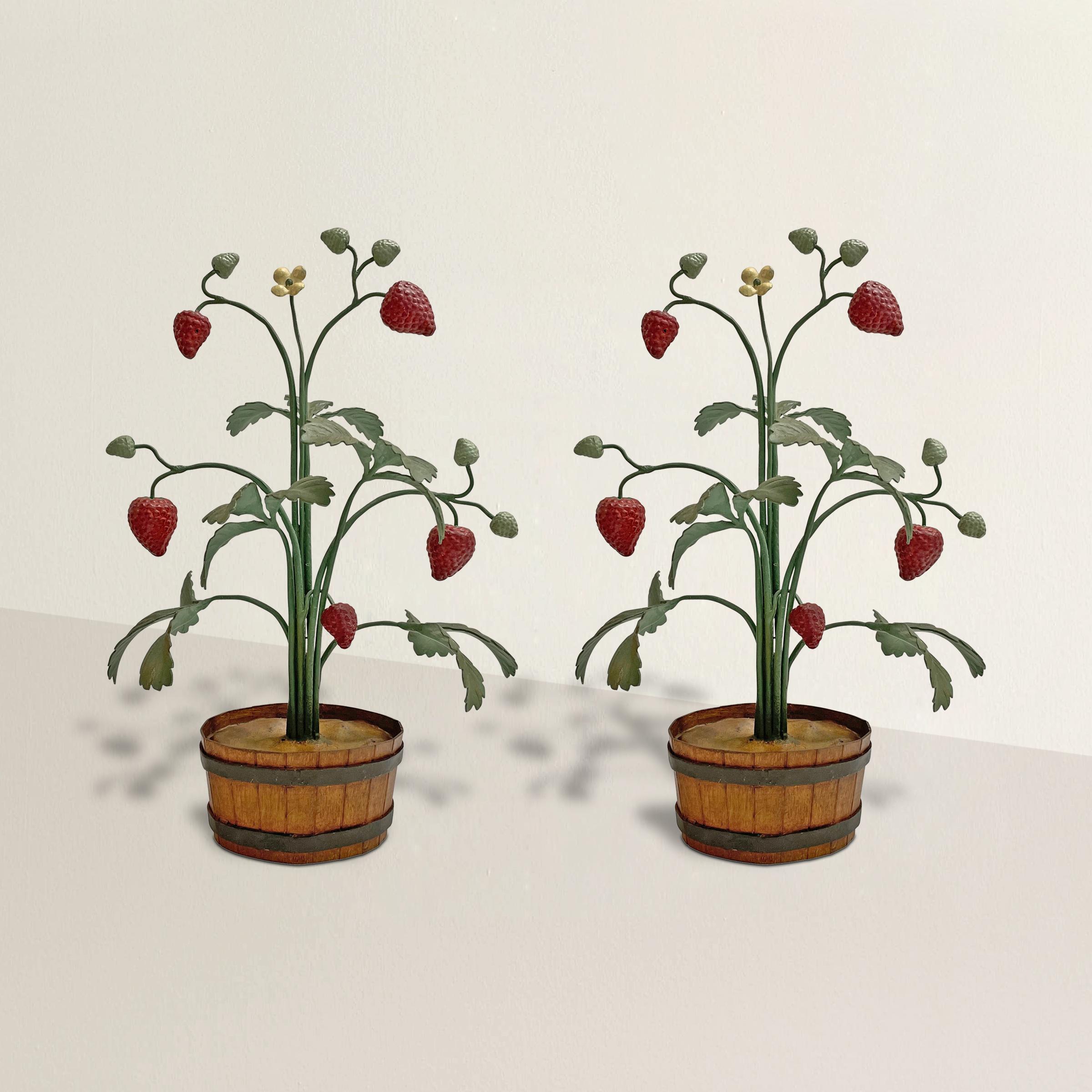 The most charming pair of vintage mid-20th century Italian tole strawberry topiaries with hand-painted leaves, berries, and flowers, and potted in tole buckets. Such a sweet pair, perfect for display on your mantel, console table, or on a shelf your
