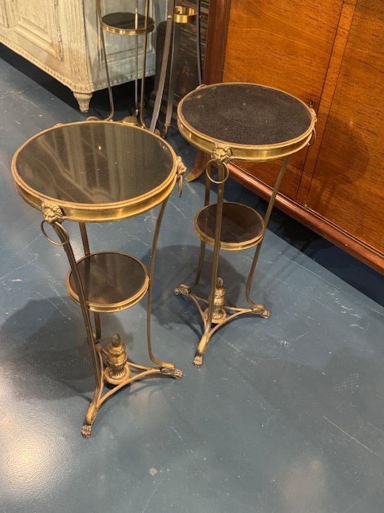 The Pair of Vintage Jansen Manner Gilt Bronze and Marble Gueridon Side Tables are stylish pieces of furniture that embody the mid-century modern aesthetic. The combination of gilt bronze and marble materials adds a touch of elegance and