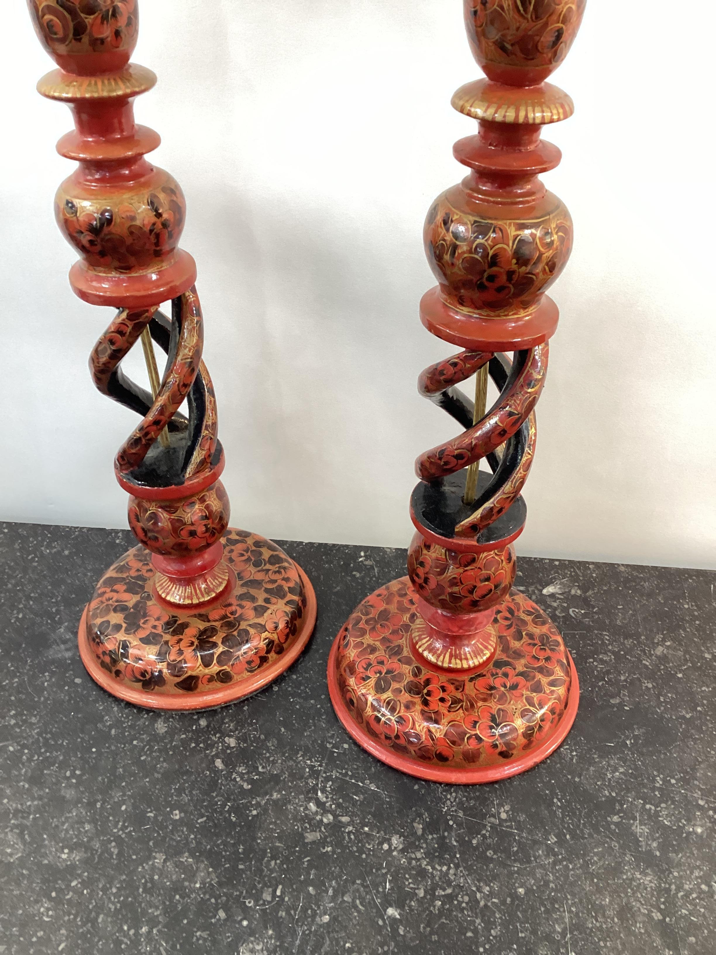  Pair of Vintage Kashmiri Candlestick Lamps with red lacquer decoration. Wired and in good working condition. Measures 17” to the top of the candlestick.