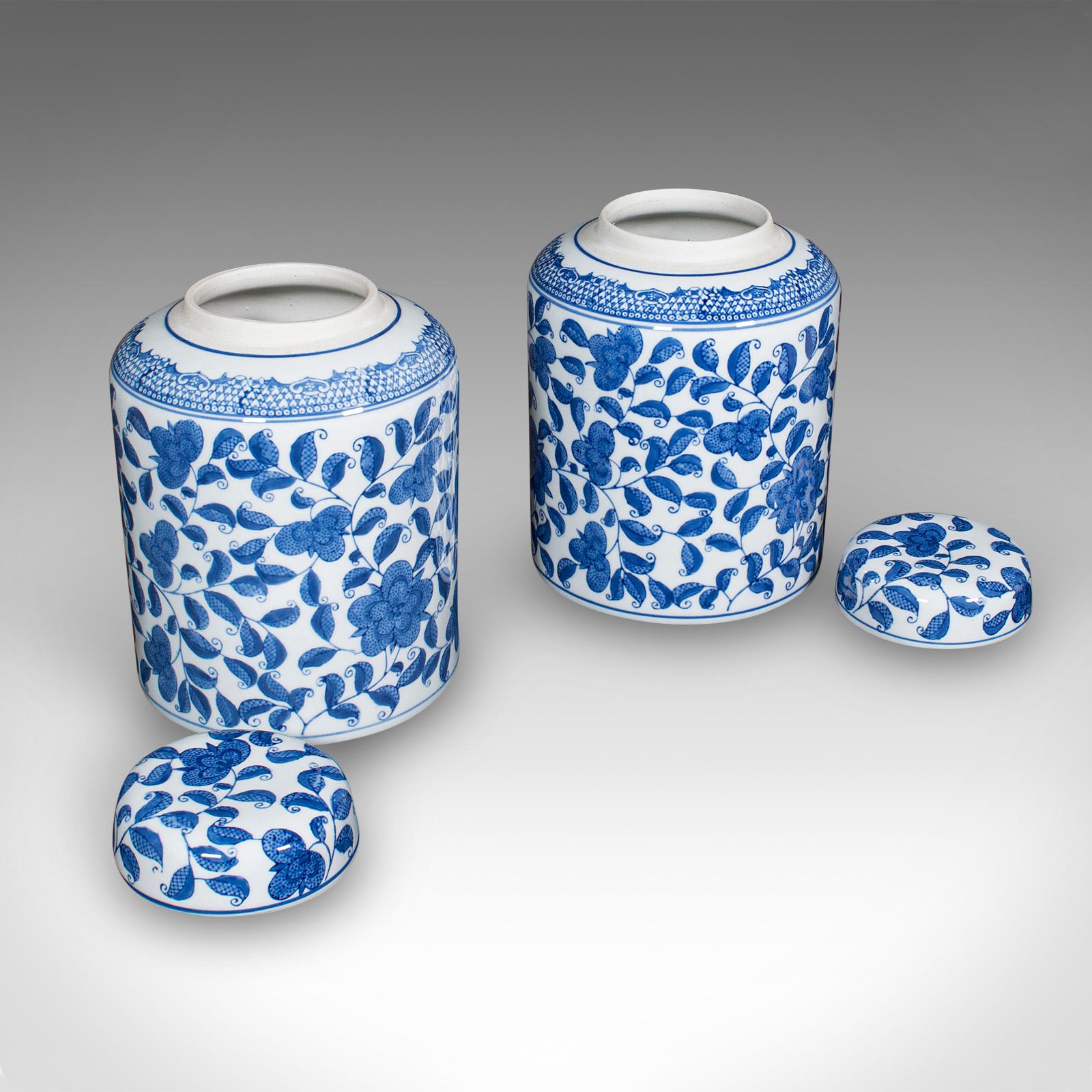 
This is a pair of vintage kitchen pantry display jars. A Chinese, ceramic blue and white covered storage urns, dating to the late 20th century, circa 1970.

Eye-catching foliate decoration adds a dash of elegance
Displays a desirable aged patina