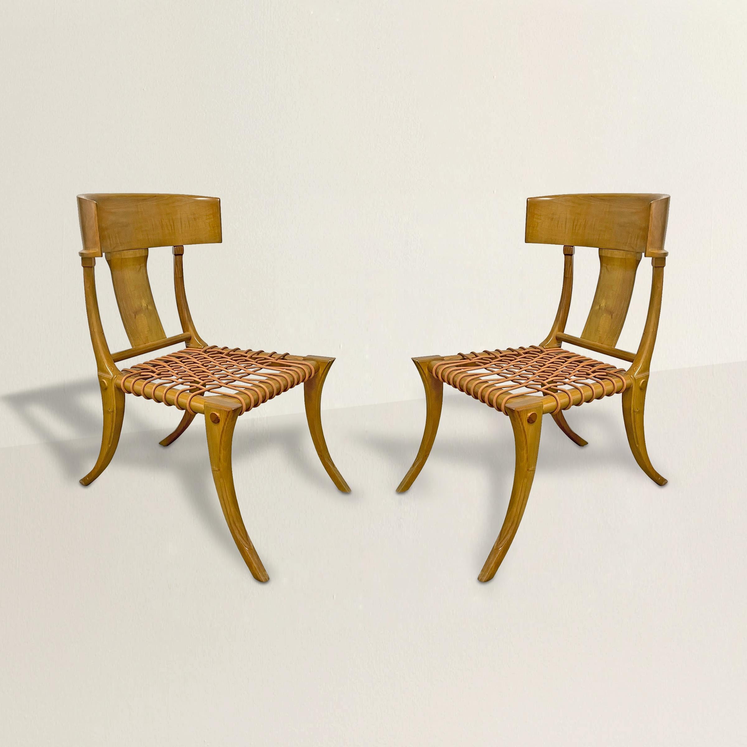 An incredible pair of late 20th century American Kreiss Klismos side chairs with a deeply curved crestrail, saber-style legs in front and back, and a woven leather seat. Chairs are perfectly scaled for use as occasional chairs in a living room or at