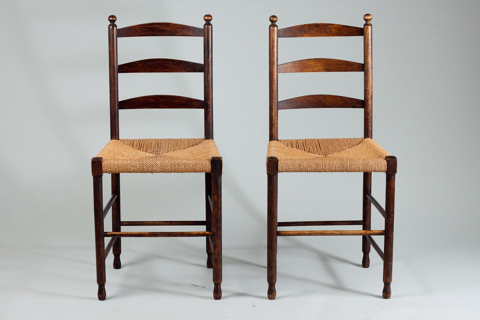 Pair of vintage Shaker style chairs with weaved rush seat and ladder style back.